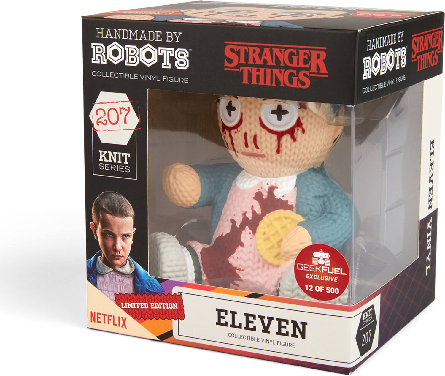 The text on the image can be grouped and corrected as follows:

- Handmade by Handmade Robots
- Stranger Things
- Collectible Vinyl Figure
- Knit Series Eleven
- Geekfuel Exclusive
- Limited Edition
- 12 of 500
- Netflix

This is a collectible vinyl figure from the "Stranger Things" series, specifically the "Knit Series Eleven," which is a limited edition of 500, with this being the 12th piece. It is a Geekfuel exclusive.