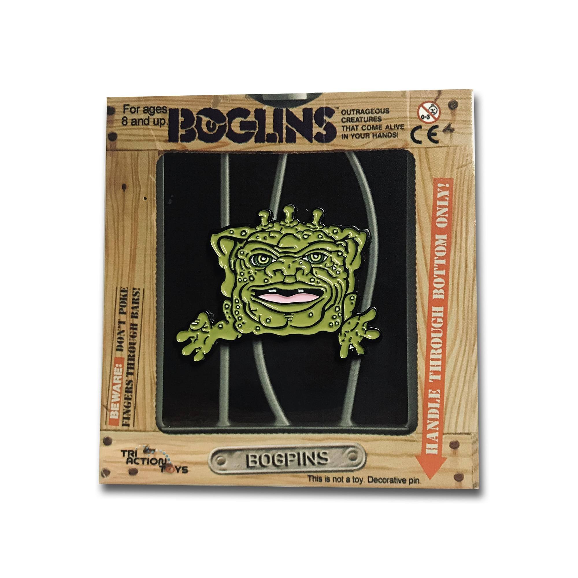 For ages 8 and up.  
BOGLINS  
OUTRAGEOUS CREATURES THAT COME ALIVE IN YOUR HANDS!  

BEWARE: FINGERS THROUGH BOTTOM POKE BARS!  
DON'T THROUGH THROUGH BEWARE: FINGERS!  
HANDLE THROUGH BOTTOM BARS!  

This is not a toy. Decorative pin.  

TRI ACTION TOYS