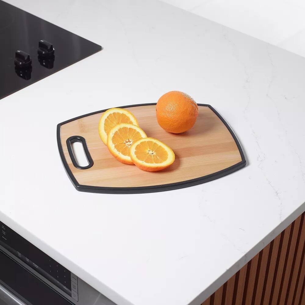 Angle. Elle Decor - 12" × 15" Kitchen Cutting Board with Handle, Durable Bamboo‑Designed Plastic, Dishwasher Safe - Brown.