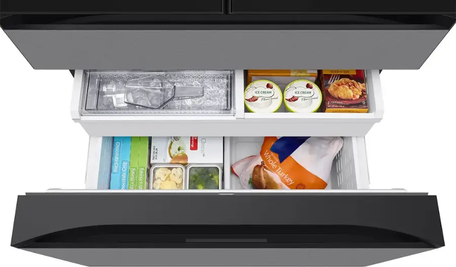 The image shows a refrigerator with its door open, revealing a variety of food items inside. There are several bottles, including a bottle of cream cheese, and a bag of chips. Additionally, there are multiple bowls containing different food items, such as a bowl of ice cream, a bowl of cheese, and a bowl of turkey. The refrigerator is well-stocked with a diverse selection of foods to choose from.
