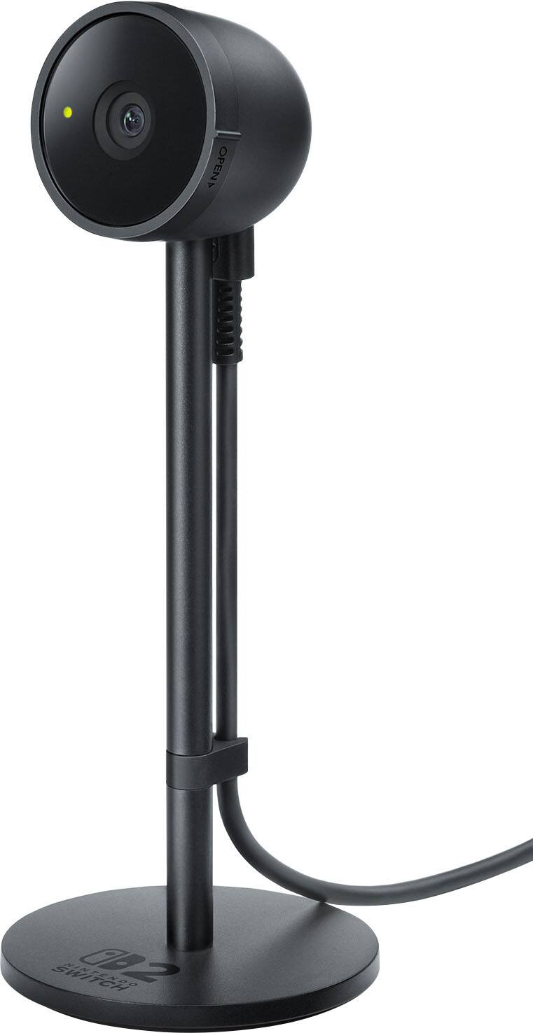 The text on the image reads "OPEN AA SWITCH NIN 002 LE CH NOO." However, it is not clear what this text represents or its relevance to the image. The image features a black camera stand with a camera attached to it, and there is a white background.