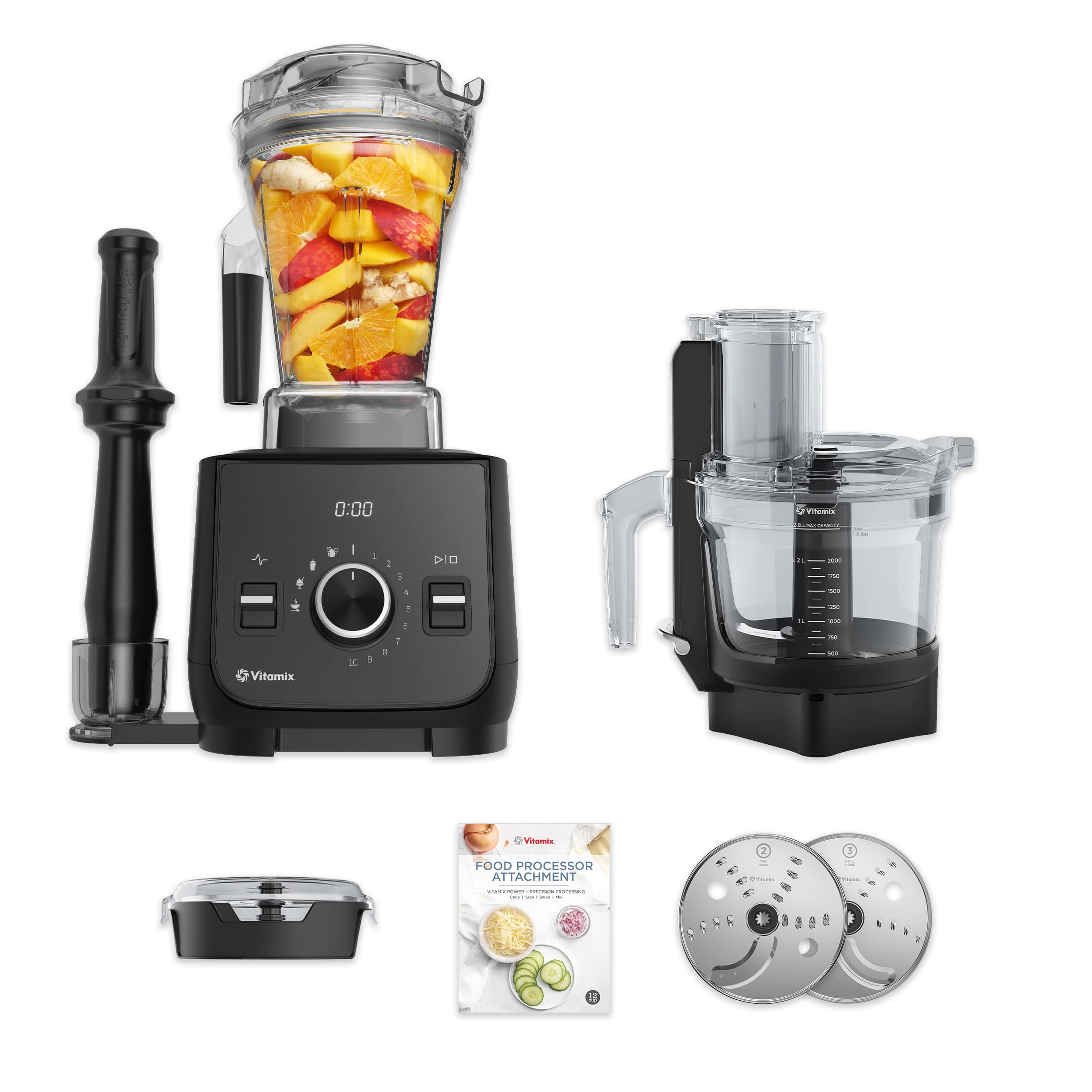 The image features a Vitamix food processor with various attachments, including a food processor attachment. The food processor is placed on top of a counter, and there is a booklet nearby, possibly providing instructions or recipes. Additionally, there is a blender in the scene, which can be used for making smoothies or other blended beverages. The image also showcases a bowl of fruit, including bananas, oranges, and apples, which can be used as ingredients for the food processor or blender.