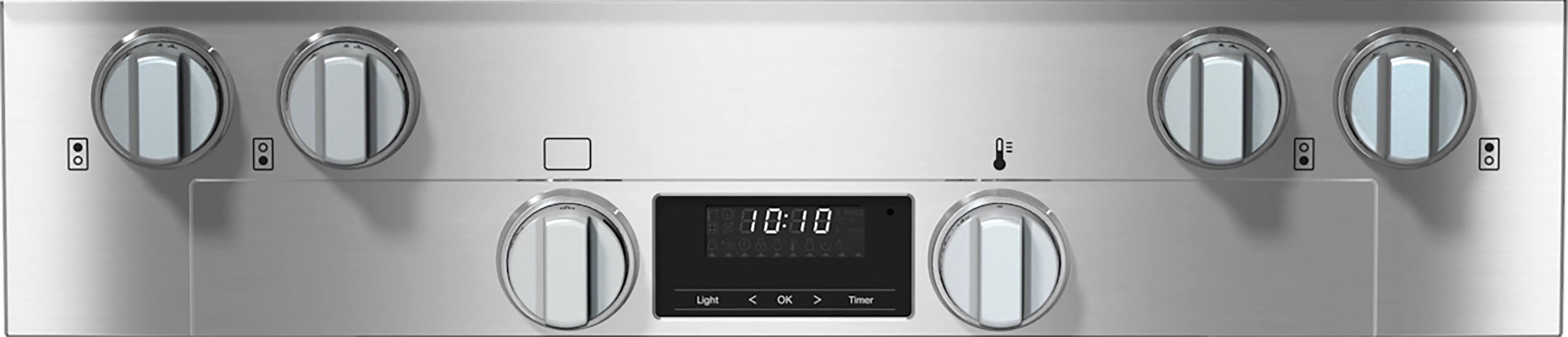The image shows a large silver appliance with a clock on it, displaying the time as 10:00. The clock is located in the middle of the appliance, and it has a timer function. The appliance has a row of four knobs, with one knob on the left, one knob on the right, and two knobs in the middle. The knobs are likely used for controlling the appliance's functions.