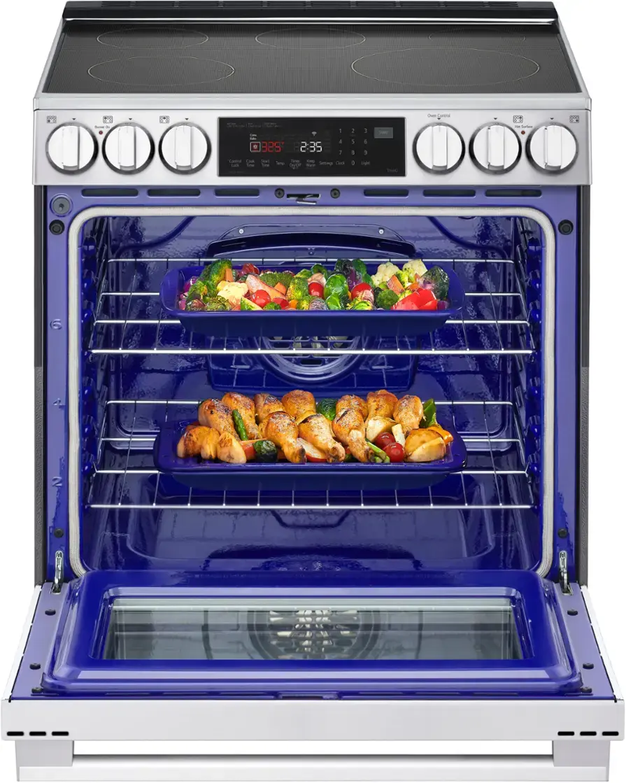 The oven is set to 325 degrees and has a timer of 2:35. There are four trays of food inside the oven, with one tray on the top rack and three trays on the bottom rack.