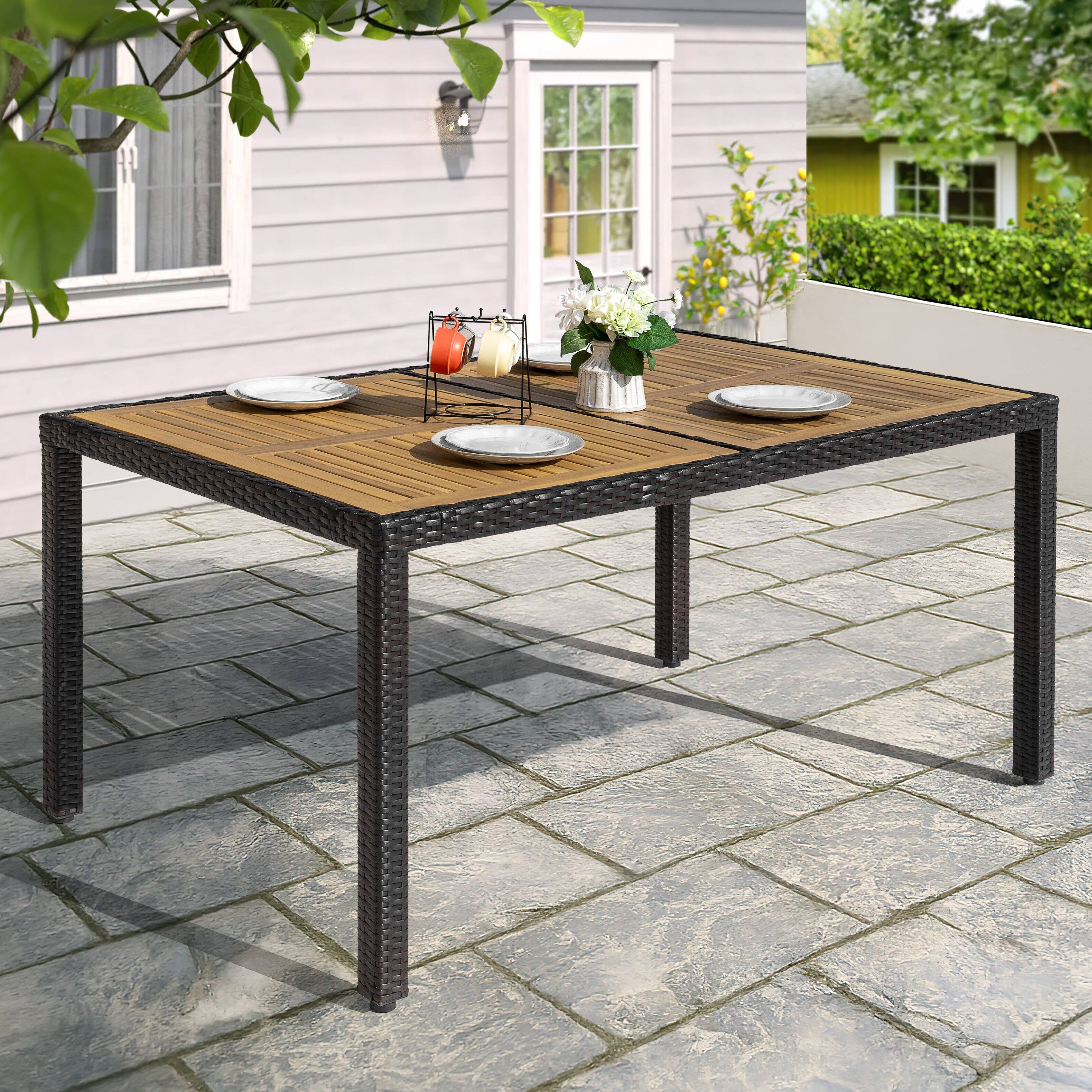 Angle. Nuu Garden - Outdoor 59" x 35" Rectangular Dining Table for 6 with Acacia Wood Slatted Tabletop, PE Rattan-Wrapped Metal Frame - Black.