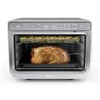 The image shows a Ninja microwave oven with a whole chicken inside, cooking on a rack. The oven is currently set to toast the chicken, and the timer is set to 145 degrees. The oven is designed to cook food quickly and efficiently, making it a popular choice for busy households.