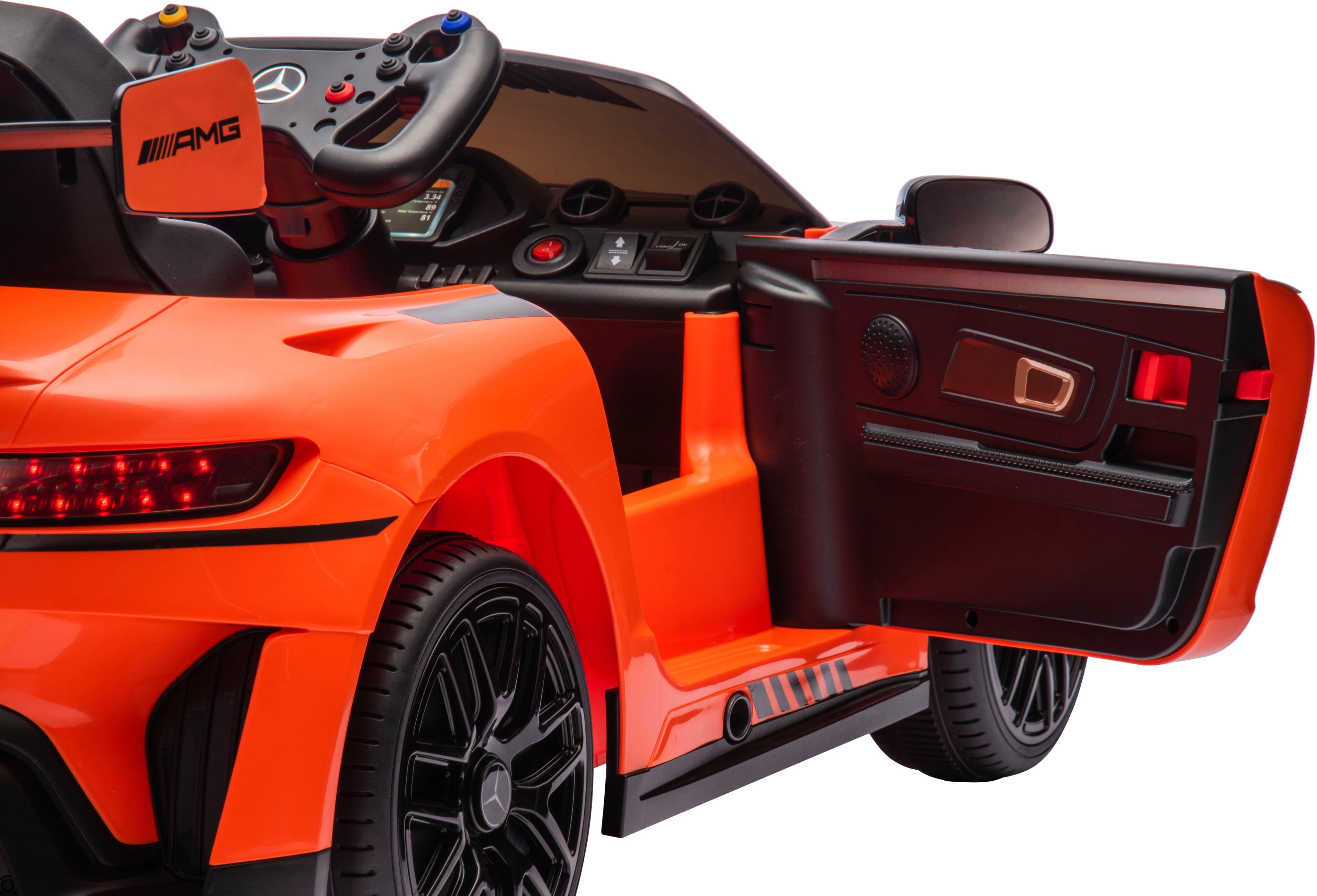 The text on the image reads "AMG J.M - a - 7 Y e." This text is likely a description or a logo for the orange toy car.