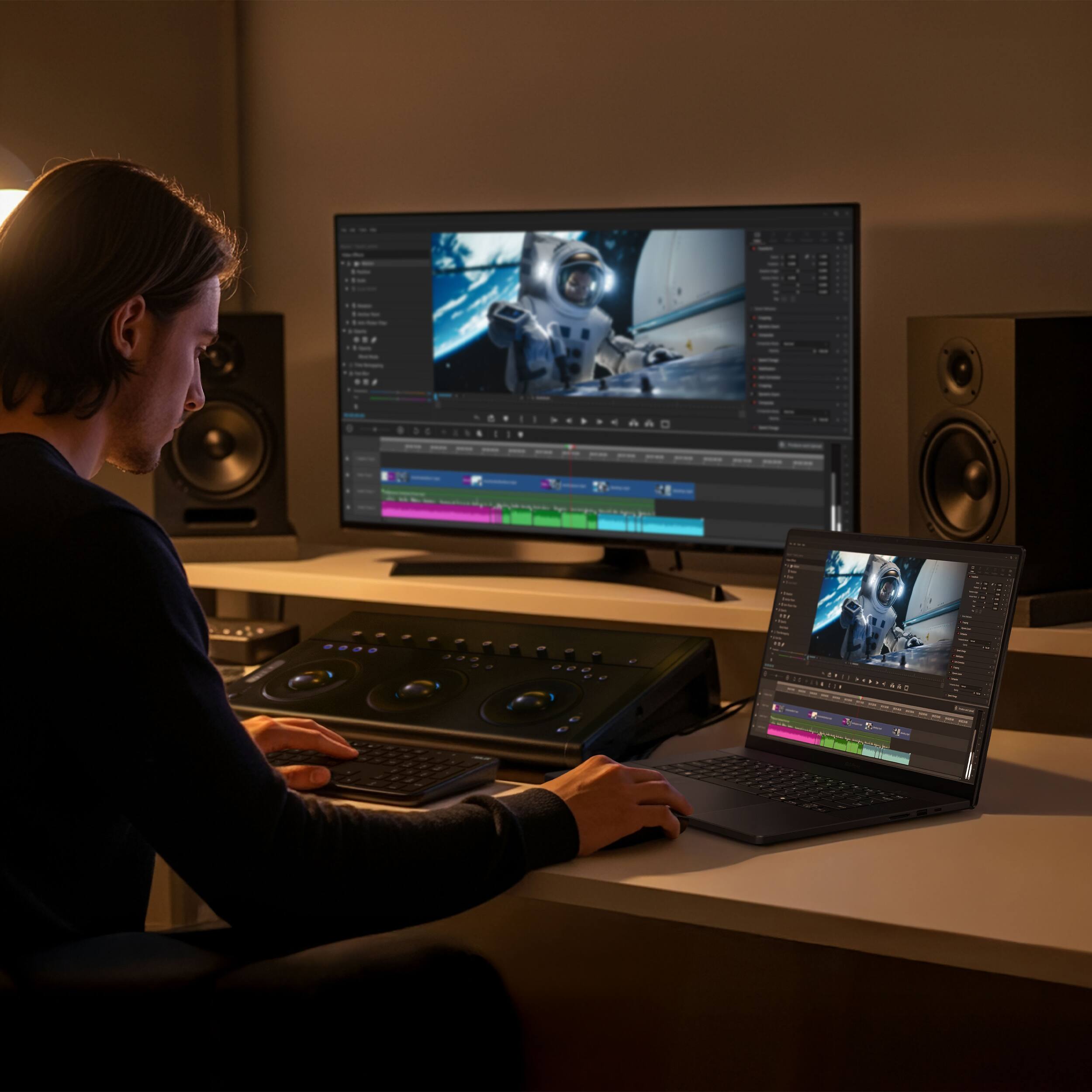 The image does not contain any visible text to group or correct. It shows a person working on a laptop and a desktop computer with a DJ controller, but there is no text present.