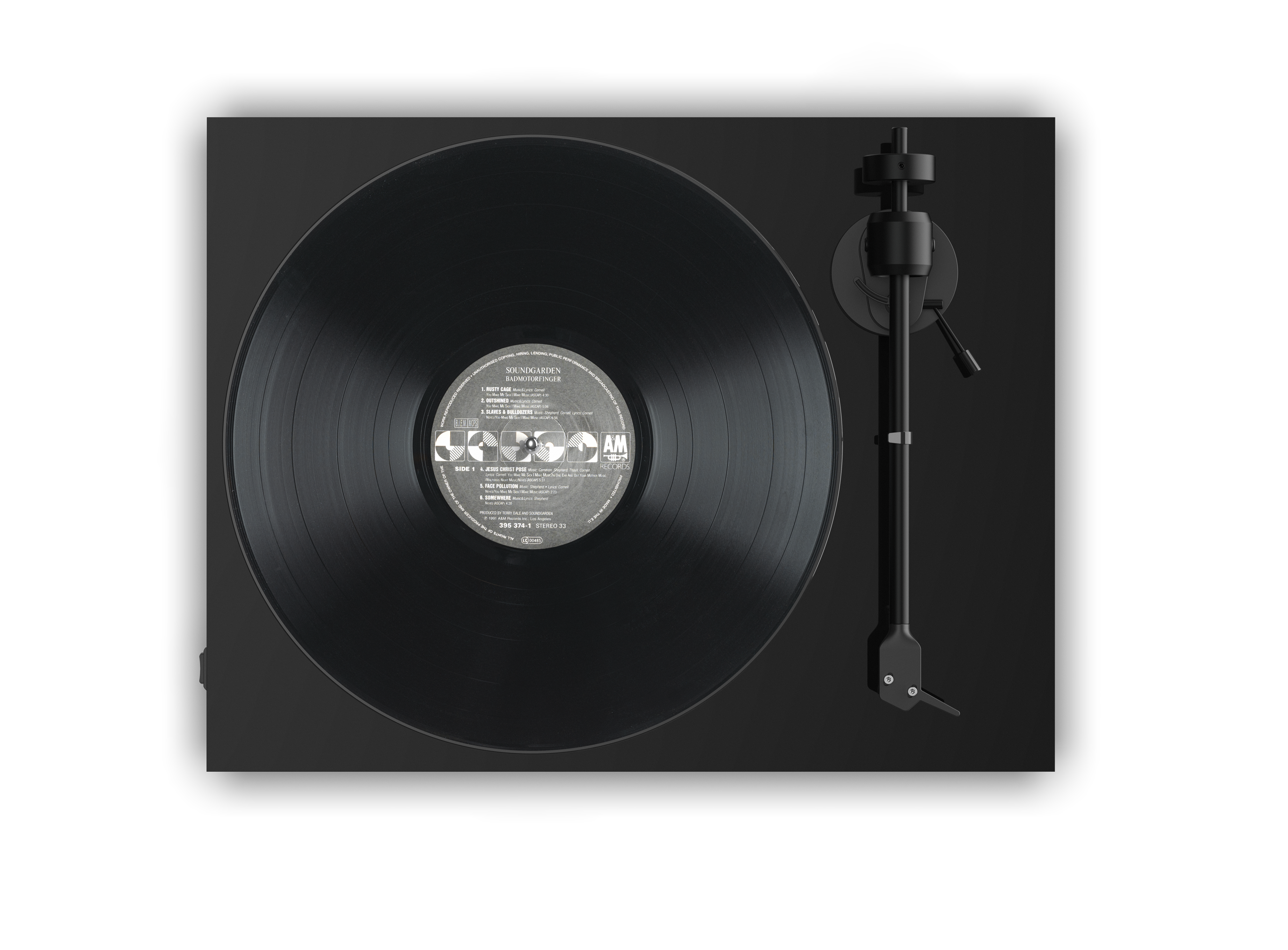 The image features a record album with a stylus on top of it. The record is black and has a silver label. The stylus is placed on the record, ready to play the music. The record is likely a 45 RPM record, as it is designed for playing music on a record player. The stylus is an essential component for playing records, as it makes contact with the record's grooves and vibrates to reproduce the sound.