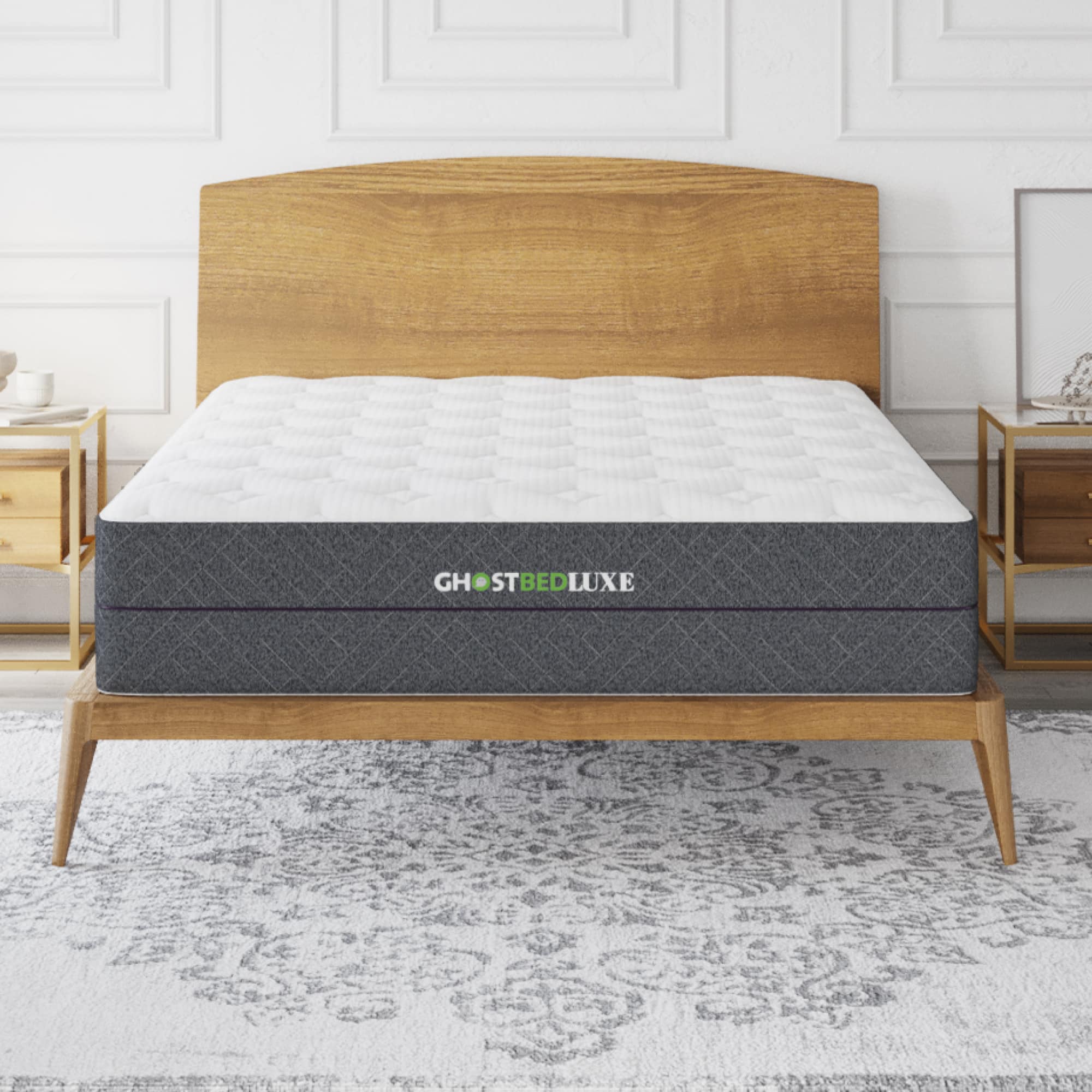 The image features a bed with a wooden headboard and a mattress. The mattress is a Ghostbed Luxe mattress, which is a high-quality and comfortable option for a good night's sleep. The bed is placed on a white carpet, and there is a nightstand next to it.