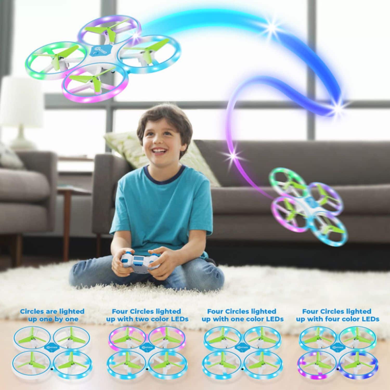 The image shows a young boy playing with a toy drone that has four different colored LED lights. The boy is sitting on a carpeted floor, holding the remote control while the drone is flying in the air. The image also features a couch in the background.