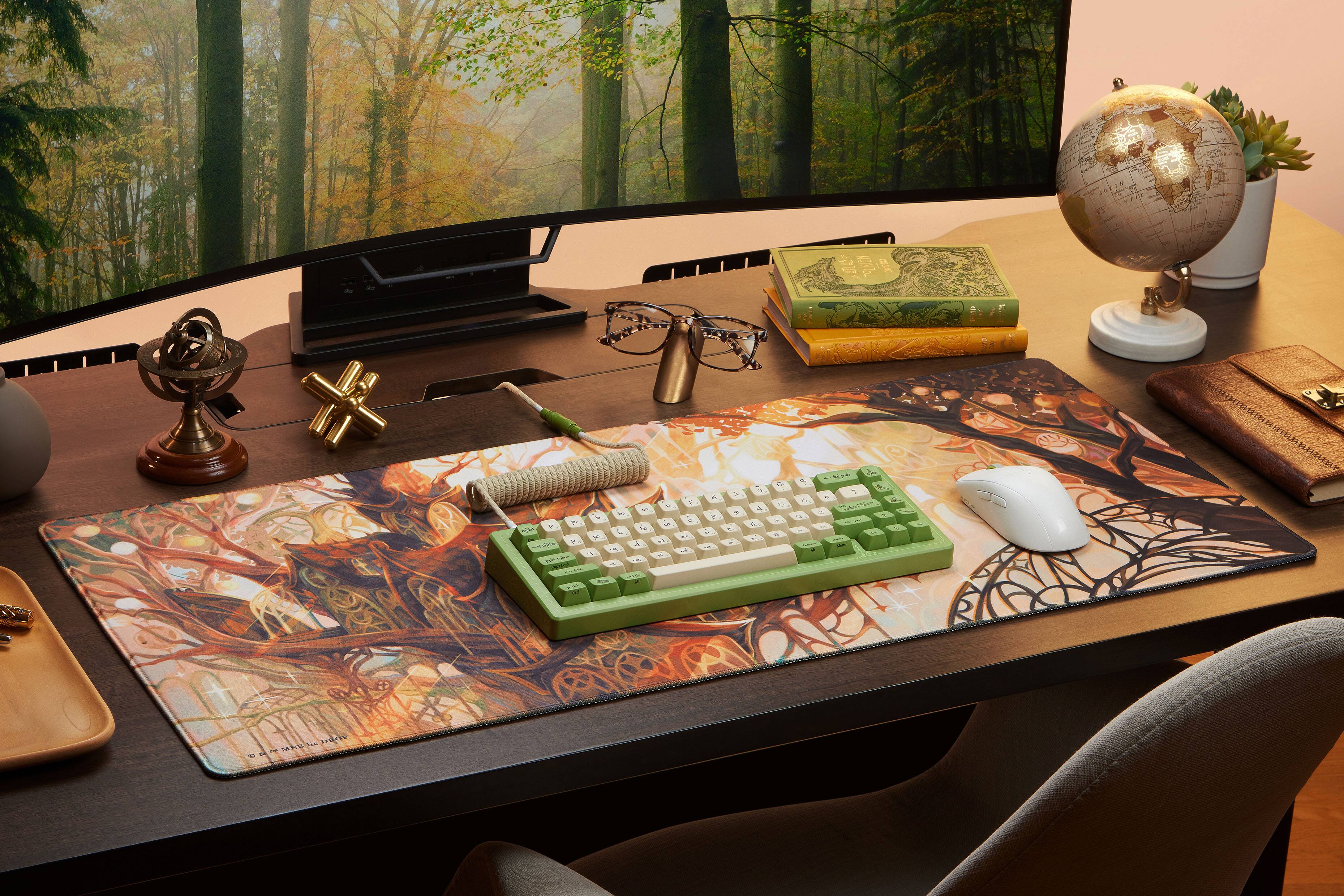 The image shows a desk with a computer setup, including a keyboard and mouse. There are also several books on the desk, as well as a clock and a globe. The desk is situated in front of a large window, providing a nice view for the person working at the desk.