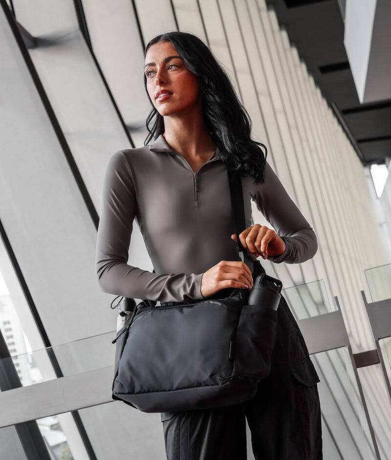 Alt View 8. ALPAKA - Laptop Messenger Satchel Bag 11L for Work & Travel, Fits 13" MacBook Air, Bottle Pockets, Luggage Pass-Through - Black Axoflux 210D.