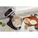 Kitchen scene with a food processor and a cutting board.
