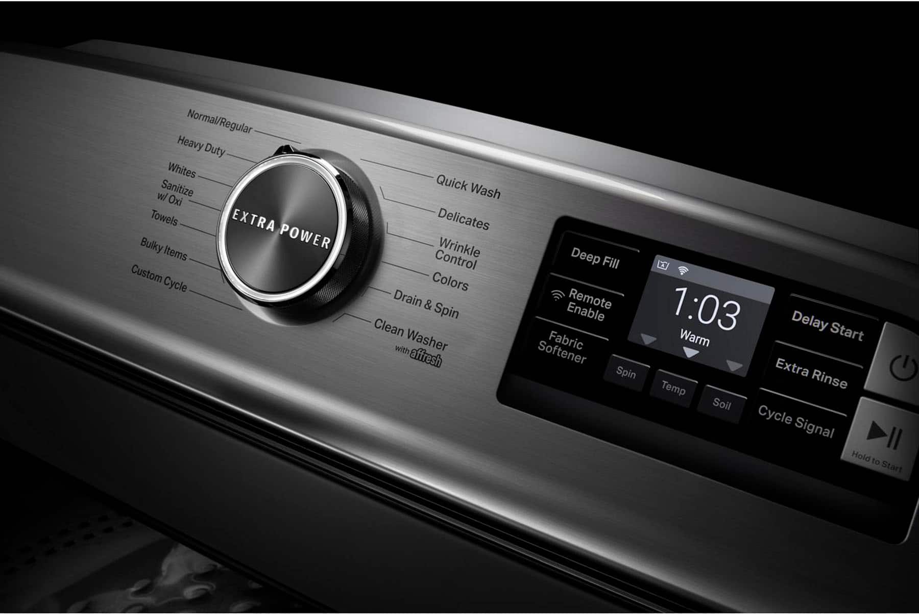 The image shows a modern oven with a digital display that shows the time as 1:03. The oven has various settings, including a quick wash, delicates, wrinkle control, and a deep fill. It also features a custom cycle, power items, and extra bulky items. The oven also has a drain and spin cycle, and it is equipped with a remote control. The display also shows the remaining time for the cycle, and there is a timer that indicates when the cycle will be completed.