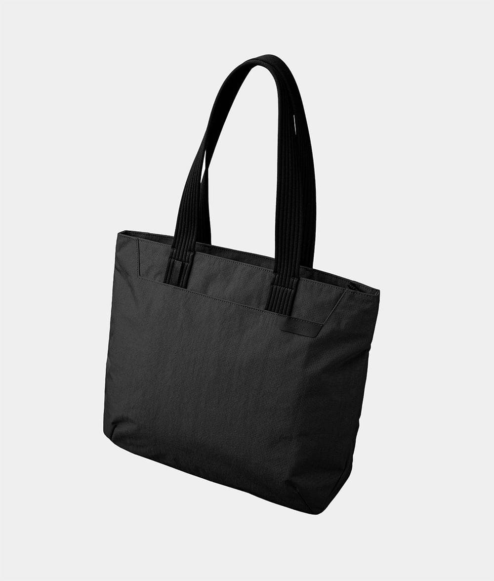 Front. ALPAKA - Flight Tote (M) Laptop Tote Bag for Work, Tote Bag Fits 14" MacBook Pro, Water Bottle Pocket, Luggage Pass-Through - Black Axoflux 400D.