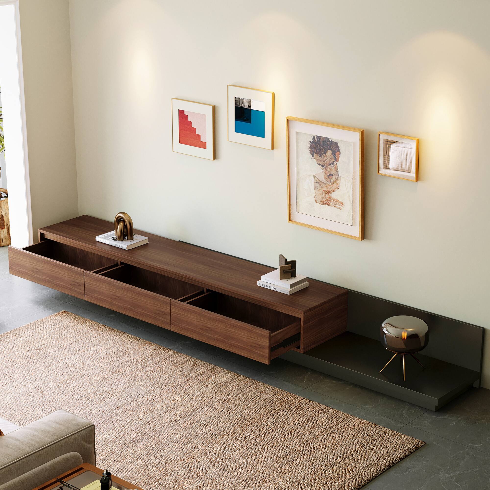 The image shows a modern living room with the following elements:

1. A wooden TV console with open shelves and drawers.
2. A small sculpture on top of the console.
3. A stack of books on the console.
4. A round stool with a metallic finish and gold legs.
5. A beige rug on the floor.
6. A light-colored sofa partially visible.
7. Four framed artworks on the wall:
   - A red abstract painting.
   - A blue abstract painting.
   - A portrait of a person.
   - A small framed item (possibly a photograph or artwork).

The room has a clean, minimalist design with a neutral color palette.