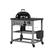 The image shows a black grill on a metal cart. The grill is placed on top of the cart, and it has a black lid. The cart is equipped with wheels, making it easy to move around. The grill is designed for outdoor cooking and is likely used for preparing various types of food.