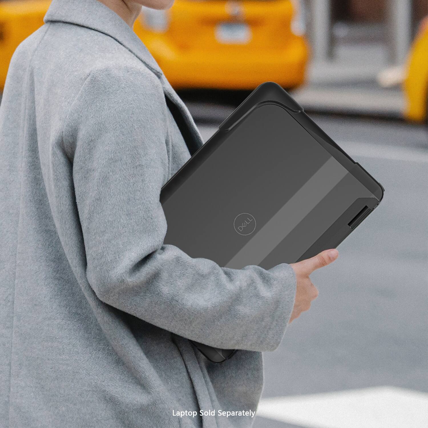 The image shows a woman wearing a gray jacket and holding a Dell laptop. The laptop is black and is being carried by the woman. The text "DELL Laptop Sold Separately" suggests that the laptop is not included with any other product or service, and it must be purchased separately.