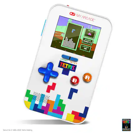 The image features a white Tetris-themed cell phone. The phone has a colorful design with Tetris-related buttons, such as "Start," "Reset," and "Score." The device is designed to resemble a classic arcade game, making it a fun and nostalgic accessory for fans of the iconic game. - T (Teen 13+)