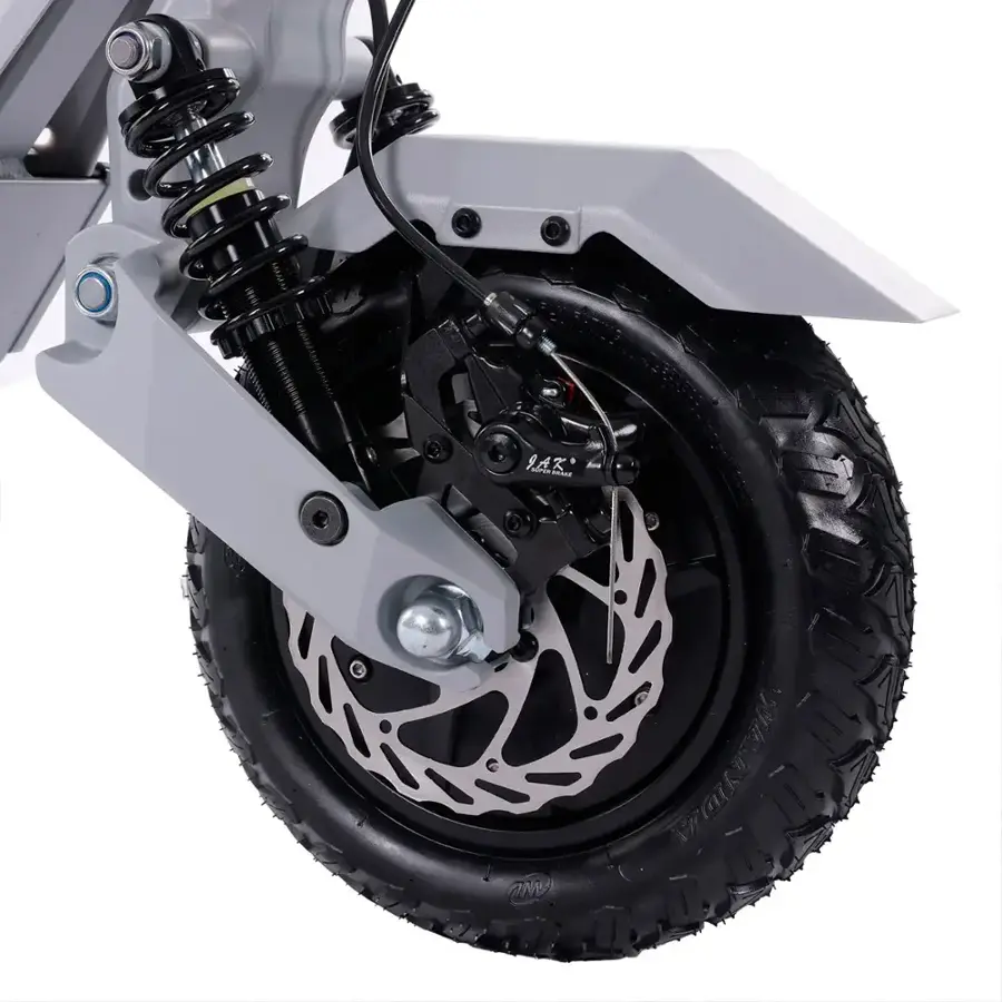 The text on the image reads "9.A.K. Fadrin inioe CaTN." However, it is not clear what this text represents or its relevance to the image. The image primarily features a close-up of a motorcycle wheel, which is the main focus of the scene.