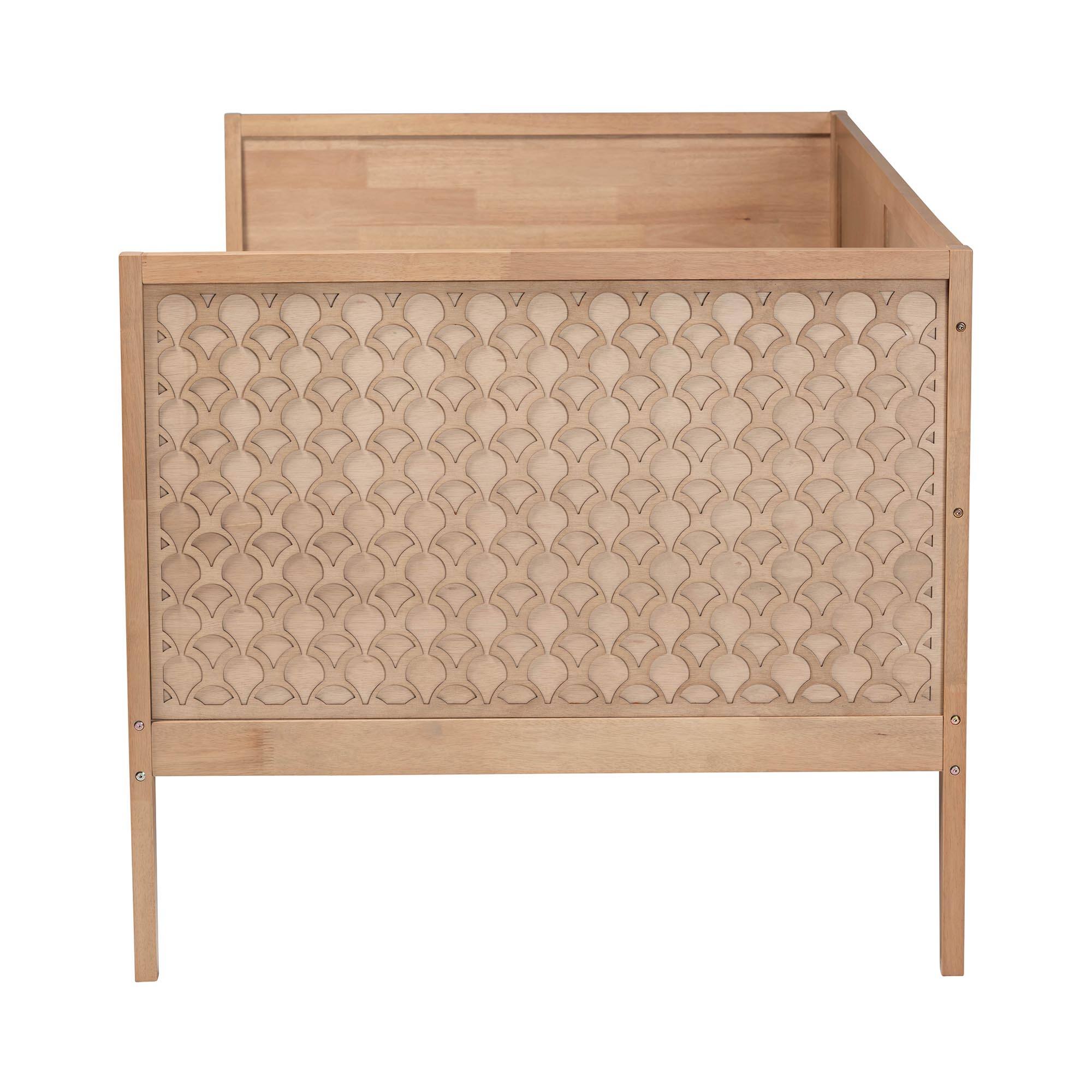 Angle. Baxton Studio - Lara Twin Daybed - Modern Wood Bed Frame with Wraparound Laser-Cut Decorative Headboard Overlay - Oak Brown.