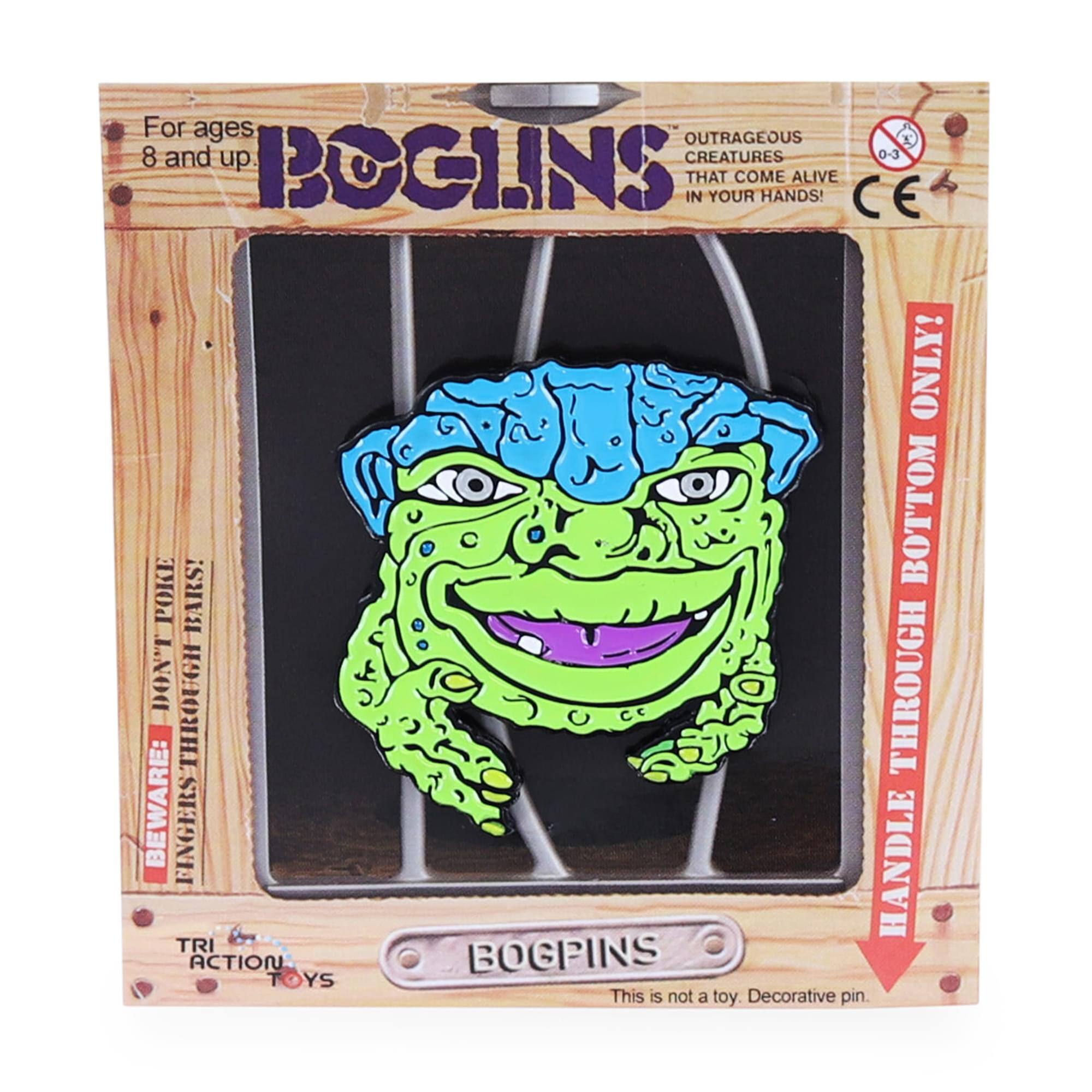 For ages 8 and up.  
BOGLINS  
OUTRAGEOUS CREATURES THAT COME ALIVE IN YOUR HANDS!  

BEWARE: FINGERS THROUGH POKE BARS!  
HANDLE THROUGH BOTTOM ONLY!  

This is not a toy. Decorative pin.