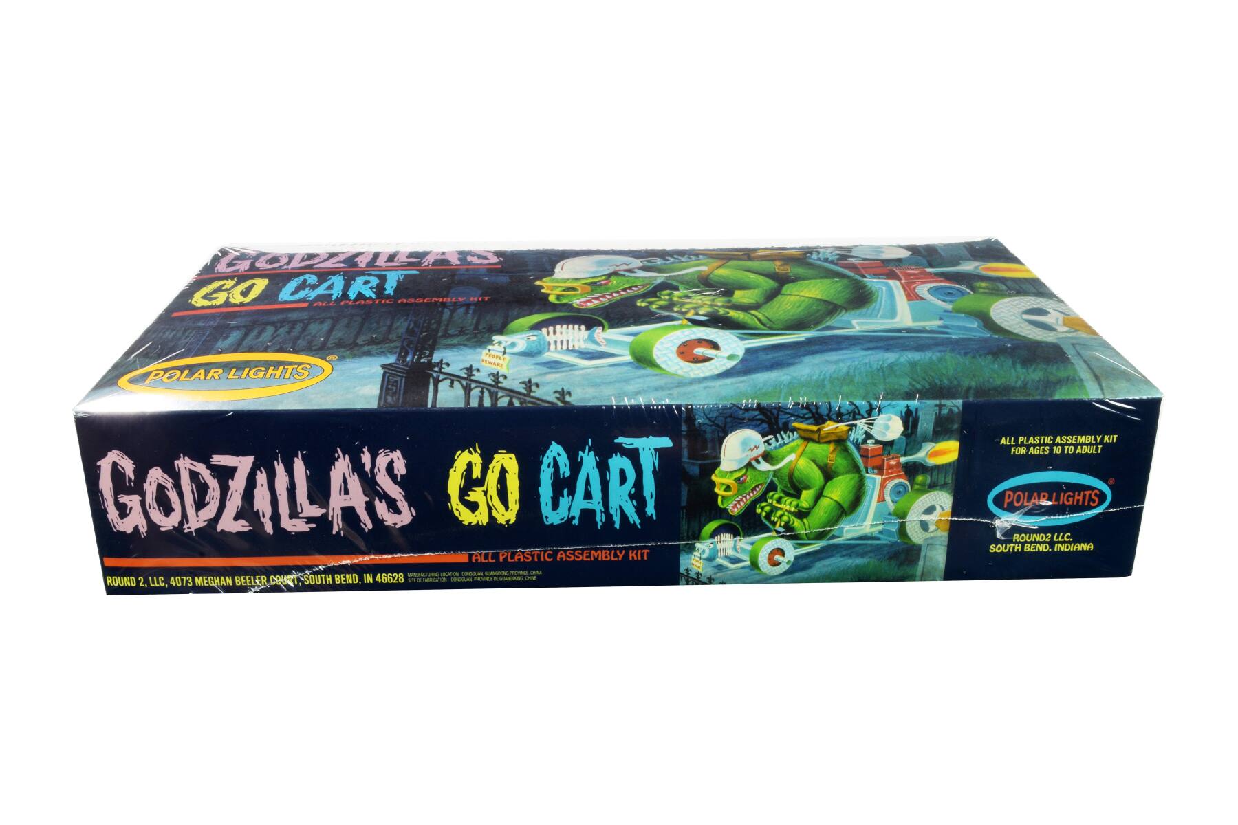 GOPDILCAS k G0 CART MaSTE AESERBLY .... TASLTEIAE ALL  P C POLAR LIGHTS Fu GODZILLA'S GO CART W ALL PLASTIC ASSEMBLY KIT SCUdLCO ddads - - Fd - ROUND 2. LLC, 4073 MEGHAN BEELER DOU SOUTH BEND, IN 46628 as da  - - - - ALL PLASTIC ASSEMBLY KIT FOR AGES TO TO ADULT . POLARLIGHTS ROUND2 LLC. SOUTH BEND. INDIANA
