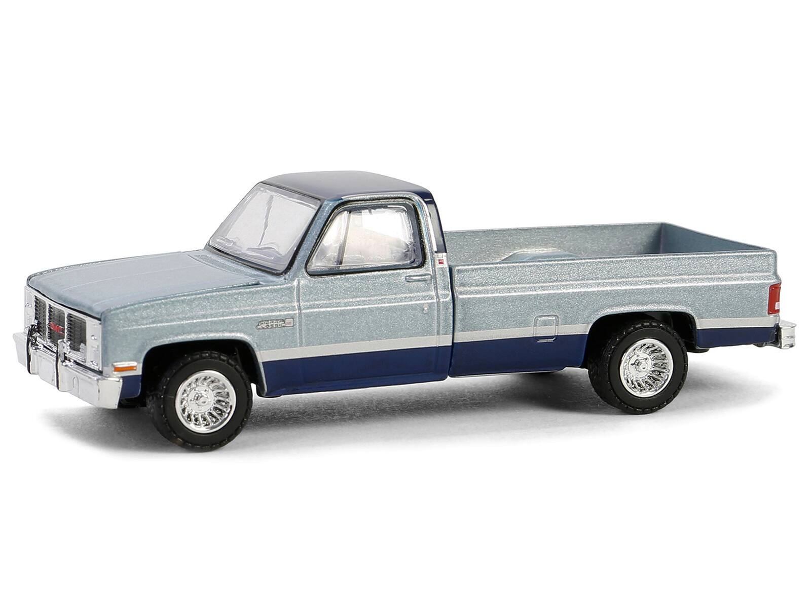 Angle. Greenlight - 1985 GMC Sierra Classic K2500 Pickup Truck Silver Metallic and Midnight Blue "Down on the Farm" Series 9 1/64 Diecast - Silver Metallic And Midnight Blue.