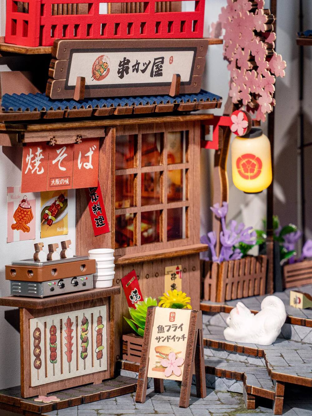 Certainly! Here is the corrected and grouped text from the image:

**Main Sign:**
- 串カツ屋 (Kushi Katsu-ya)

**Left Side:**
- 焼そば (Yakisoba)
- 大阪の味 (Osaka's Flavor)
- 料理 (Ryori - Food)

**Right Side:**
- 魚フライ (Uo Furai - Fried Fish)
- サバドライチ (Saba Drychi - Mackerel Drychi)

**Additional Text:**
- Rollie (appears on small signs with illustrations of food items)