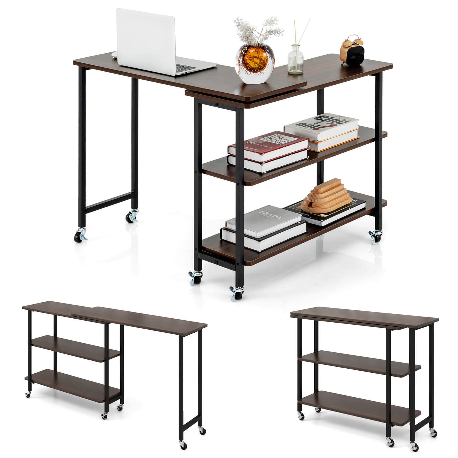 The image shows a wooden table with a laptop, books, and a vase on it. The table is accompanied by a shelf and a small table. There are several books on the table, including a book by Prada. The table is placed on a wheeled cart, making it easy to move around. The overall scene suggests a workspace or a study area.