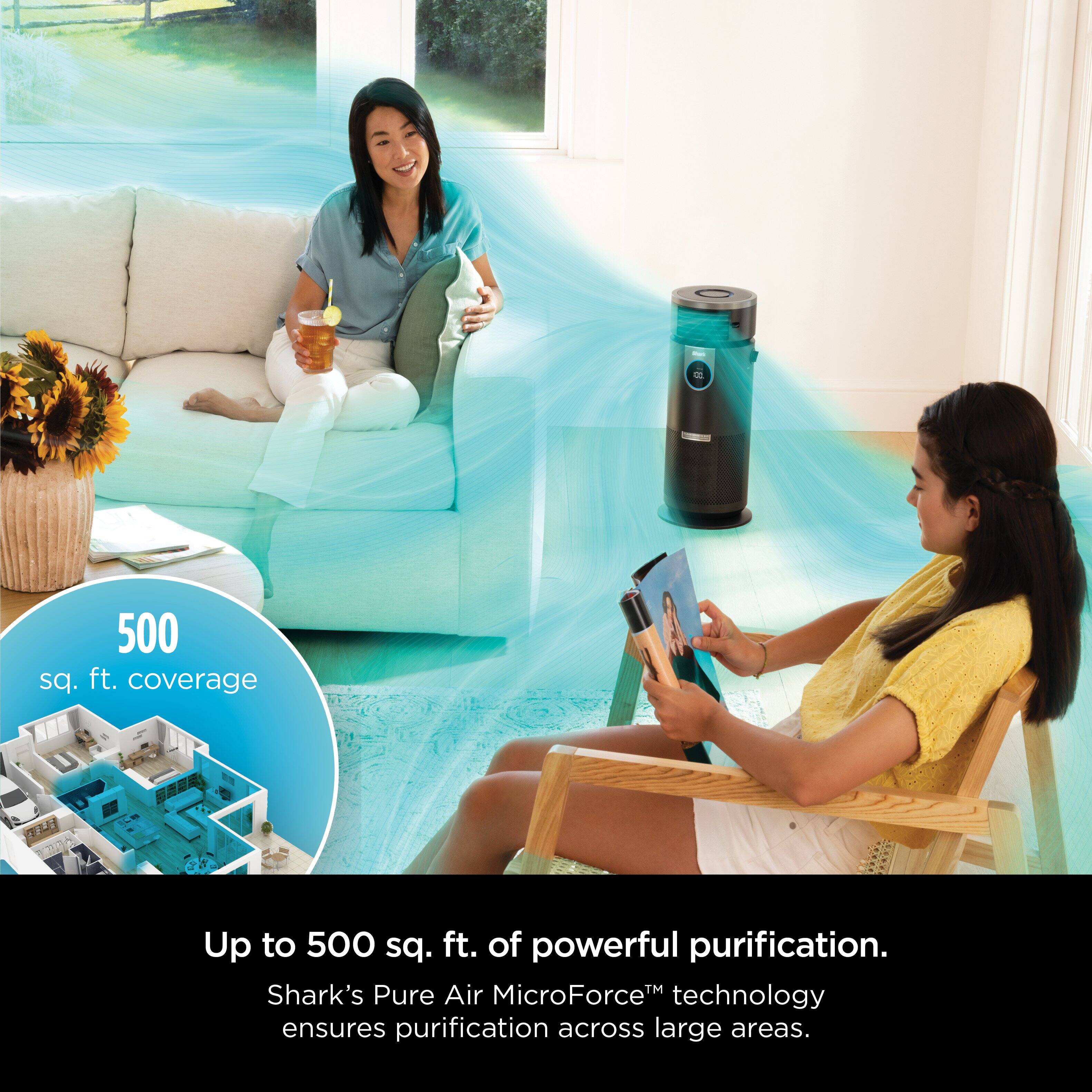 The image features two women sitting in a living room, with one of them holding a tablet. The room has a couch and a potted plant, and there is a window nearby. The focus of the image is on the air purifier, which is described as having a 500 sq. ft. coverage and utilizing Shark's Pure Air MicroForce technology to ensure purification across large areas.