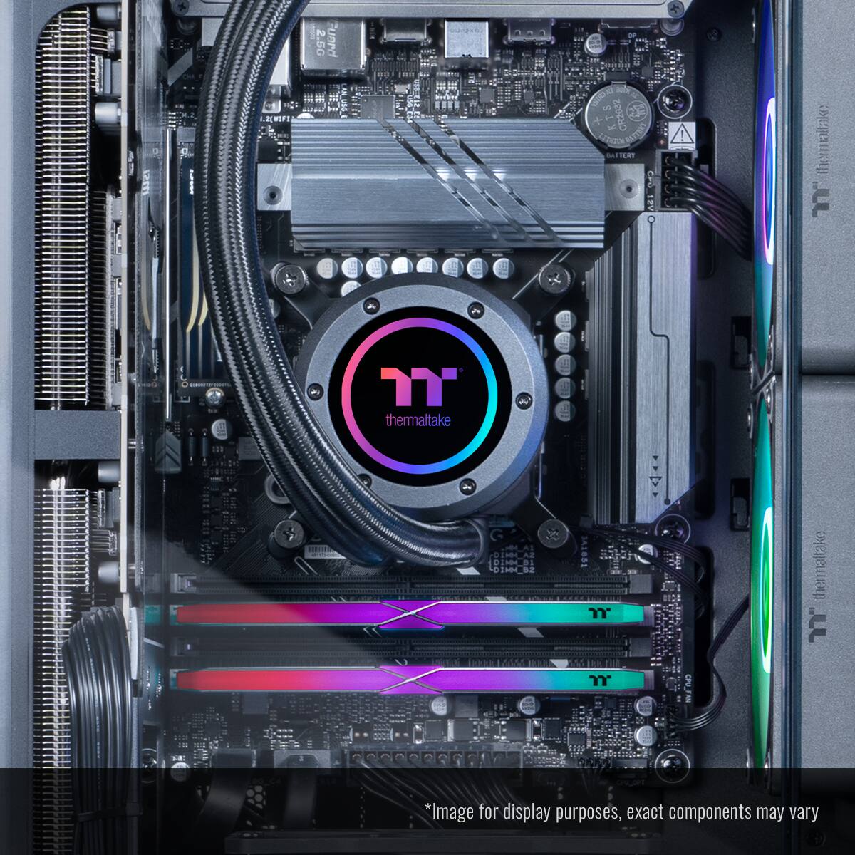 The image shows a computer's internal components, including a motherboard, a CPU, and a cooling system. The motherboard has a Thermaltake logo on it, indicating that it is a Thermaltake product. The cooling system features a colorful design, with a rainbow-colored fan and a colorful heatsink. The image is meant for display purposes, but the actual components may vary.
