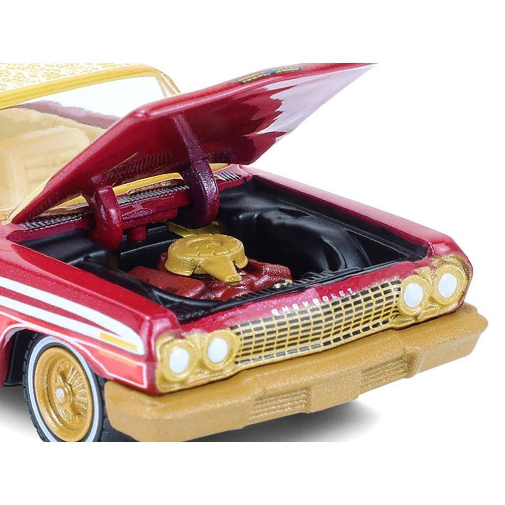 Angle. Greenlight - 1963 Chevrolet Impala Lowrider Michael Heralda Special Edition Red Metallic Cream Top Gold Graphics Hobby Exclusive 1/64 - Red Metallic Cream Top Gold.