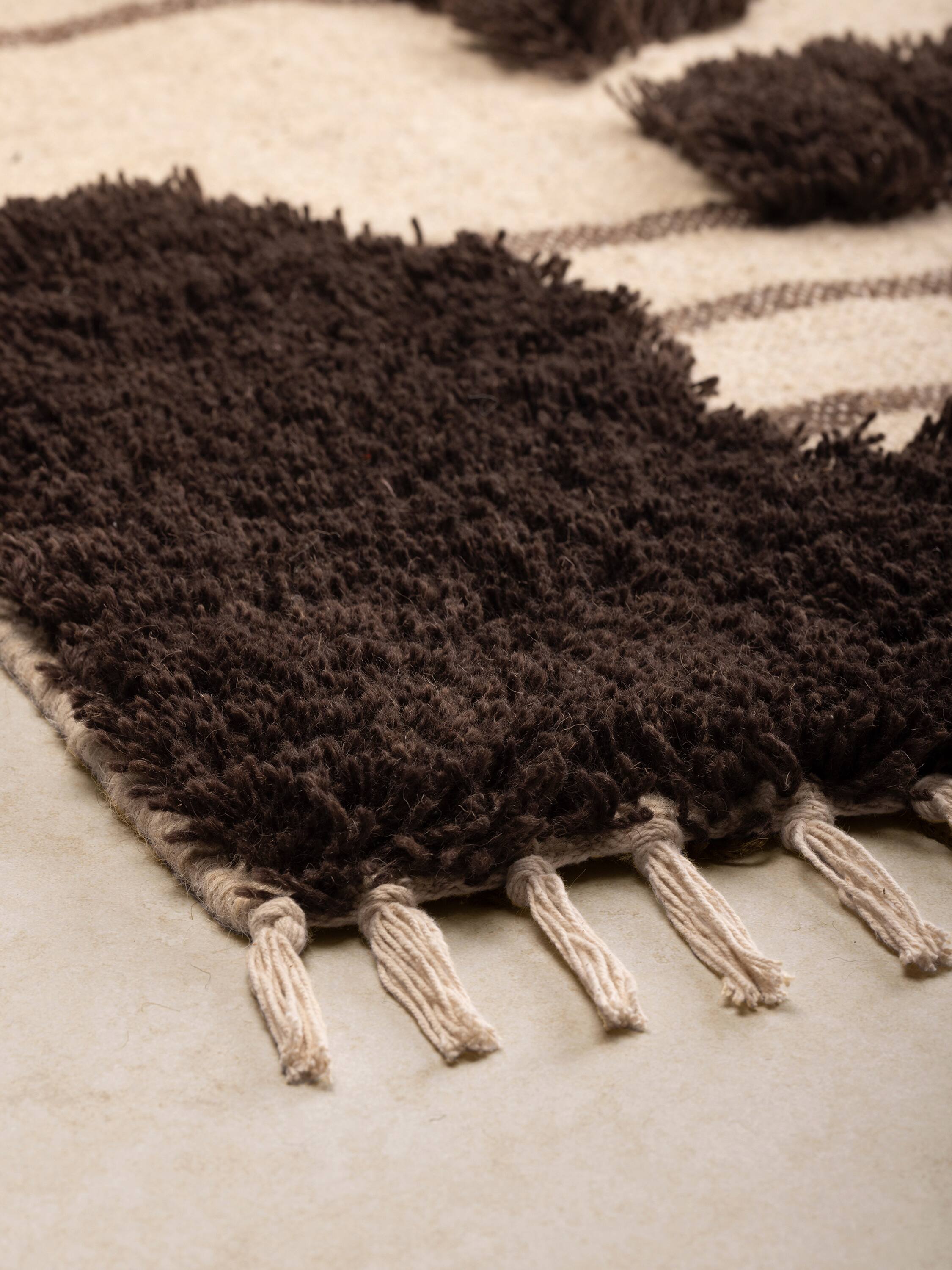 Left. GAURI KOHLI - Nasik Rug - Shades of brown and beige.