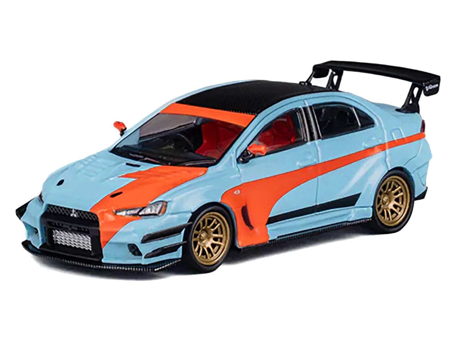 Left. CM Models - Mitsubishi Lancer Evolution X Varis RHD (Right Hand Drive) Light Blue with Black Top and Orange Stripes 1/64 - Light Blue and Black.