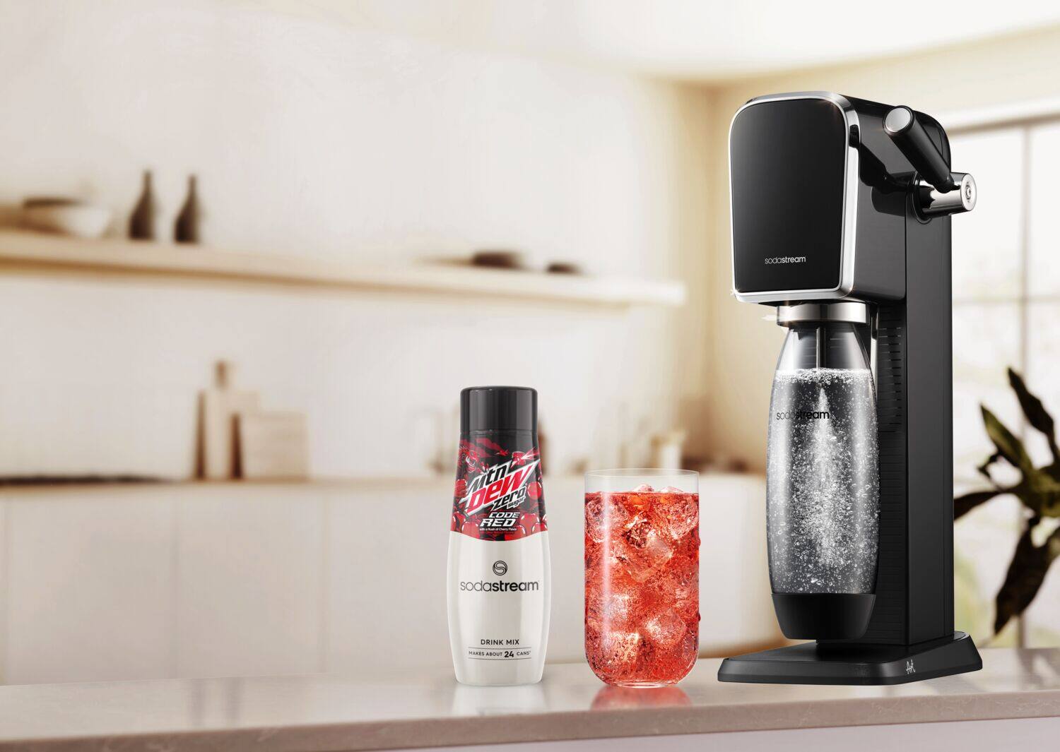The image features a counter with a SodaStream machine, a bottle of Mountain Dew, and a glass of red liquid. The text on the image reads: "Mountain Dew Zero Sugar, SodaStream, and a glass of red liquid."