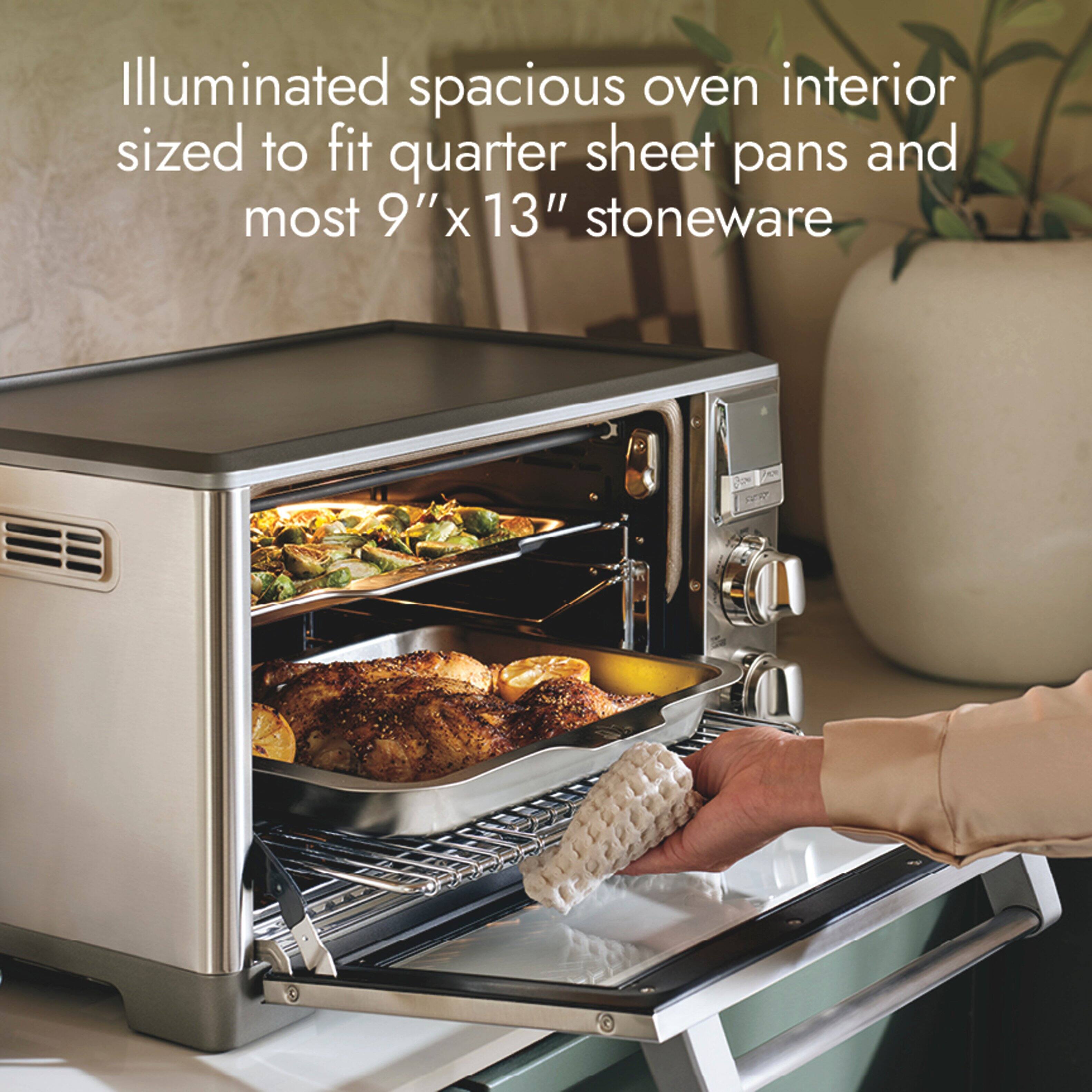 Illuminated spacious oven interior sized to fit quarter sheet pans and most 9"x 13" stoneware