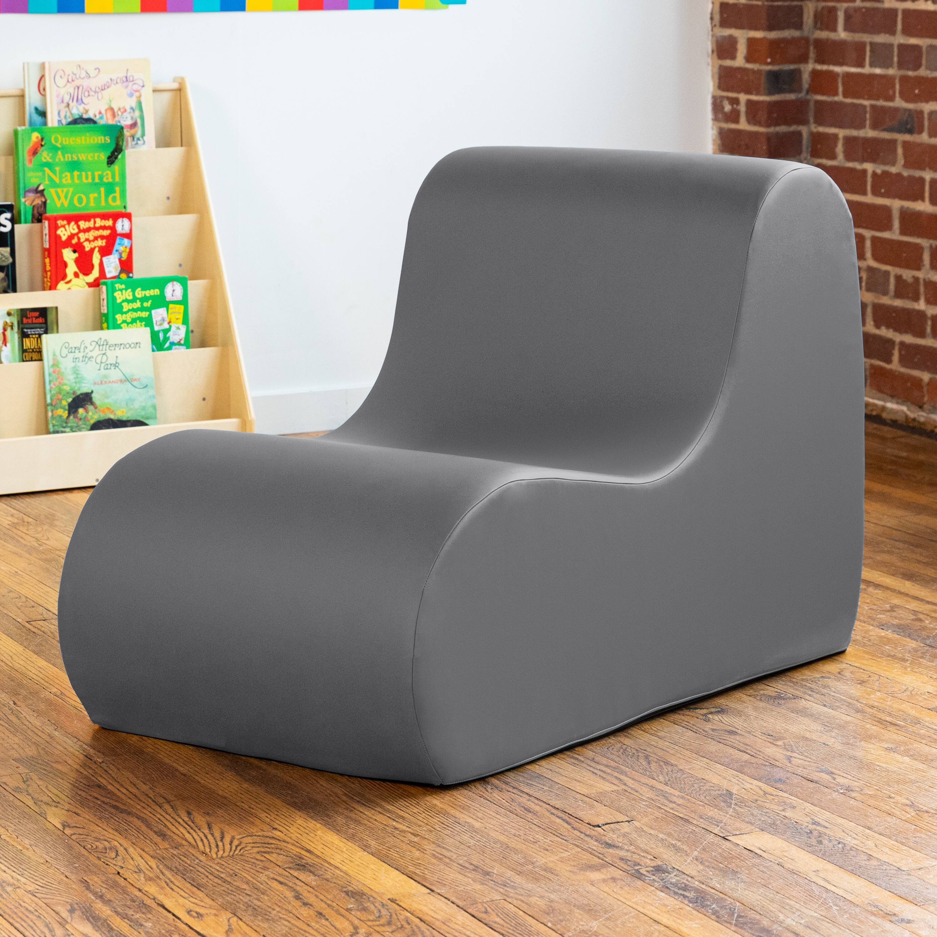 Sure, here is the corrected and grouped text from the image:

1. **Books on the Shelf:**
   - "Carla's Wonderful World"
   - "Questions & Answers Natural World"
   - "Big Red Book of Dinosaurs"
   - "Big Green Book of Bugs"
   - "Carla's Afternoon in the Park"

2. **Text on the Chair:**
   - "S Cars ogarad"
   - "2 Questions & Answers Natural World"
   - "P Tod Bo"
   - "BIG af pg Booke"
   - "I - BAG Green Bouk"
   - "yagater"
   - "al RN IO"
   - "Crale Nernoon OP"
   - "e R Park a"