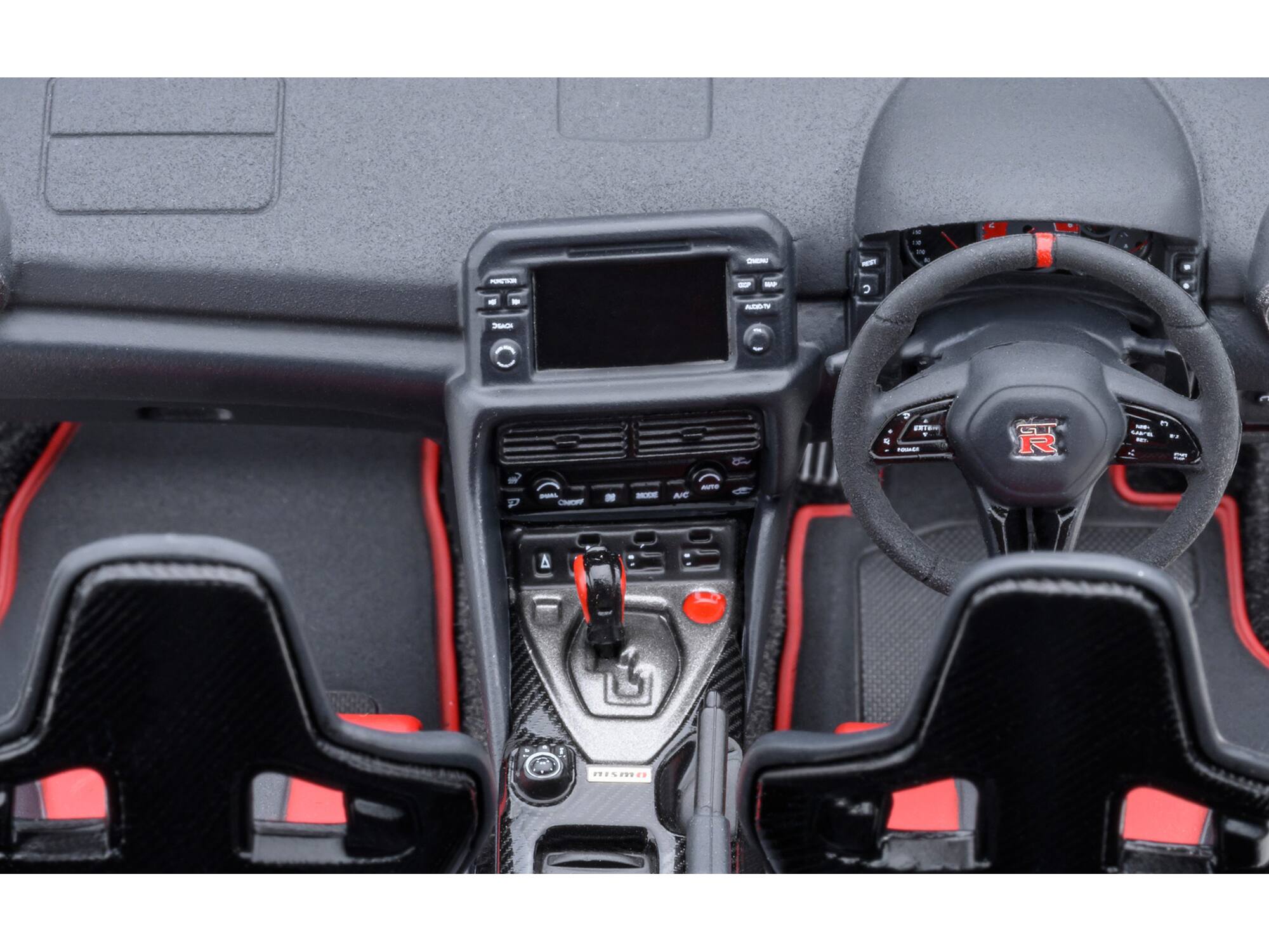 The text in the image appears to be:

- "TR"
- "AIC"
- "I%P"

These are likely part of the branding or model information on the car's interior.