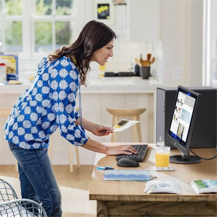 Left. HP - HP OmniDesk Desktop Intel Core Ultra 5, 16 GB;1 TB SSD  Windows 11 Home - Dark wood, jack black chassis.