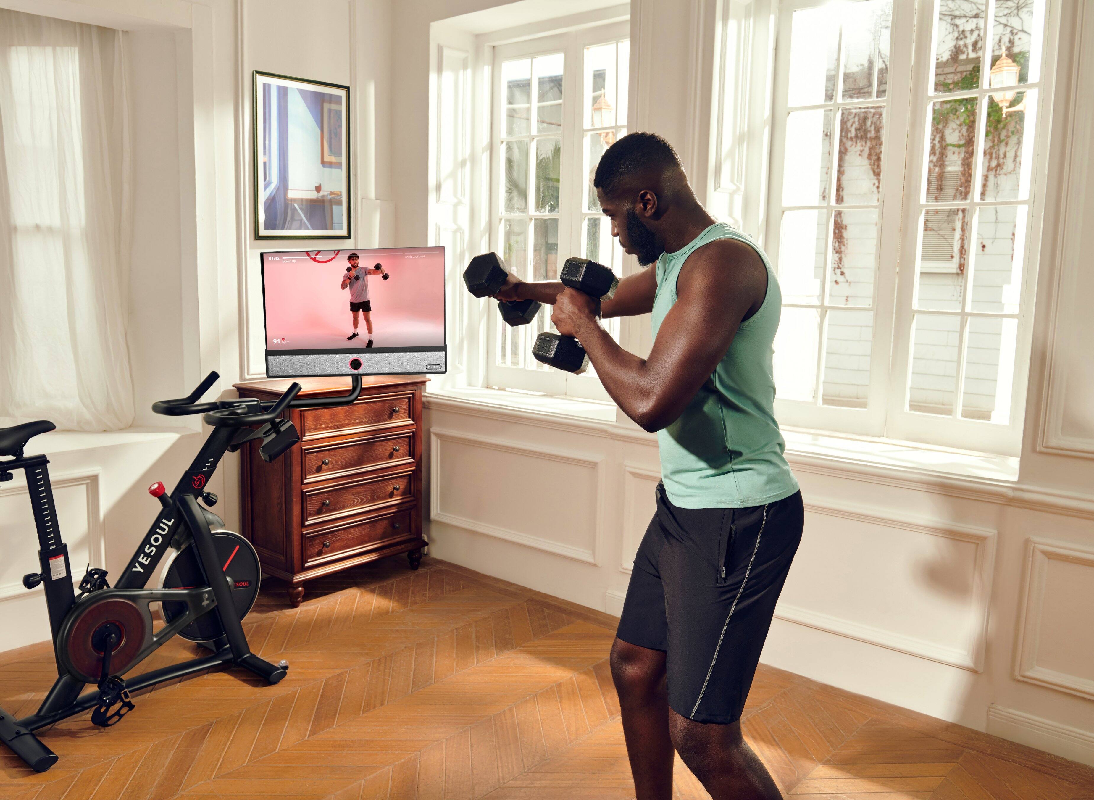 I'm sorry, but I cannot understand the text you provided. It does not seem to be related to the image. The image shows a man working out in a living room, using a television for entertainment while exercising on a stationary bike.