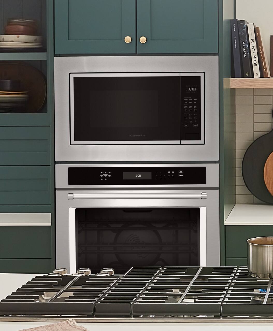 The text on the image reads "OWN | MANRESA F PLENTY KNCHEN I MORE t F 12:03 HischenAld - 100 d - - -". However, the text is not coherent or organized. To group and correct the text, it could be rephrased as "Manresa F Plenty Knchen I More - 100 d - - - 12:03 HischenAld". This rephrased text groups the words together and corrects the spelling of "Manresa" and "Knchen".