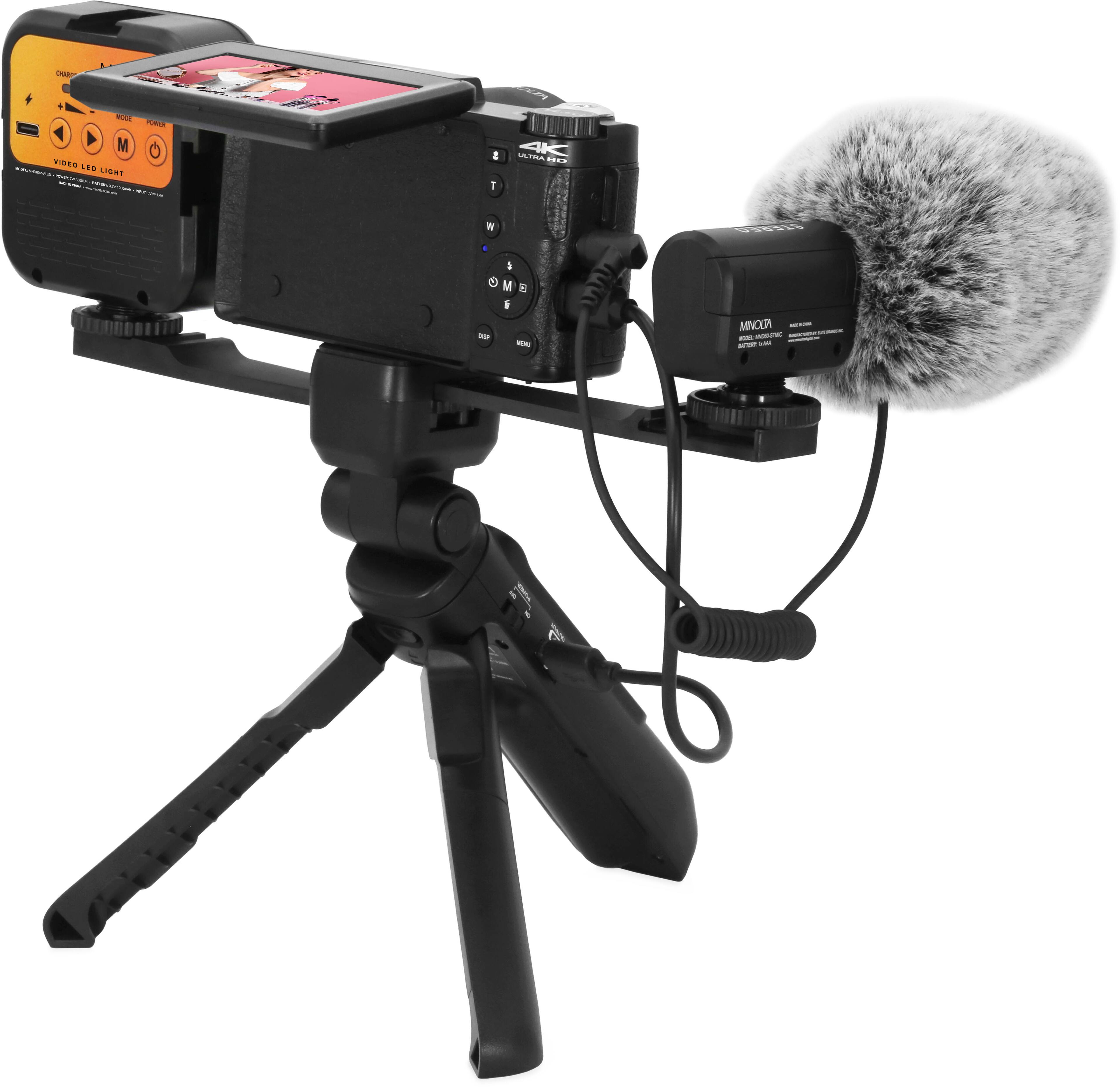 The image features a camera tripod with a microphone attached to it. The microphone is positioned above the camera, ready to capture audio for any video recording. The tripod is black and has a stand for the camera, ensuring stability during use.
