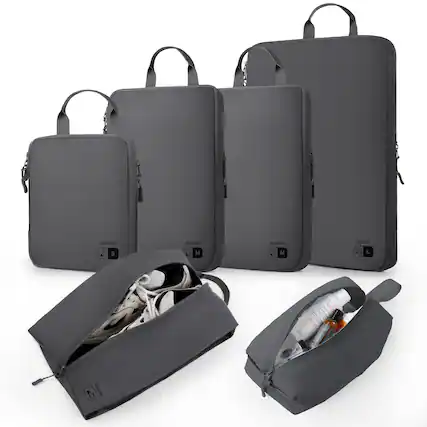 The image features a collection of black bags, including a backpack and a handbag. The backpack is open, revealing its contents, which include a bottle and a cell phone. The handbag is also open, showing its contents, which include a bottle, a cell phone, and a laptop. The bags are arranged in a way that allows for easy access to their contents.