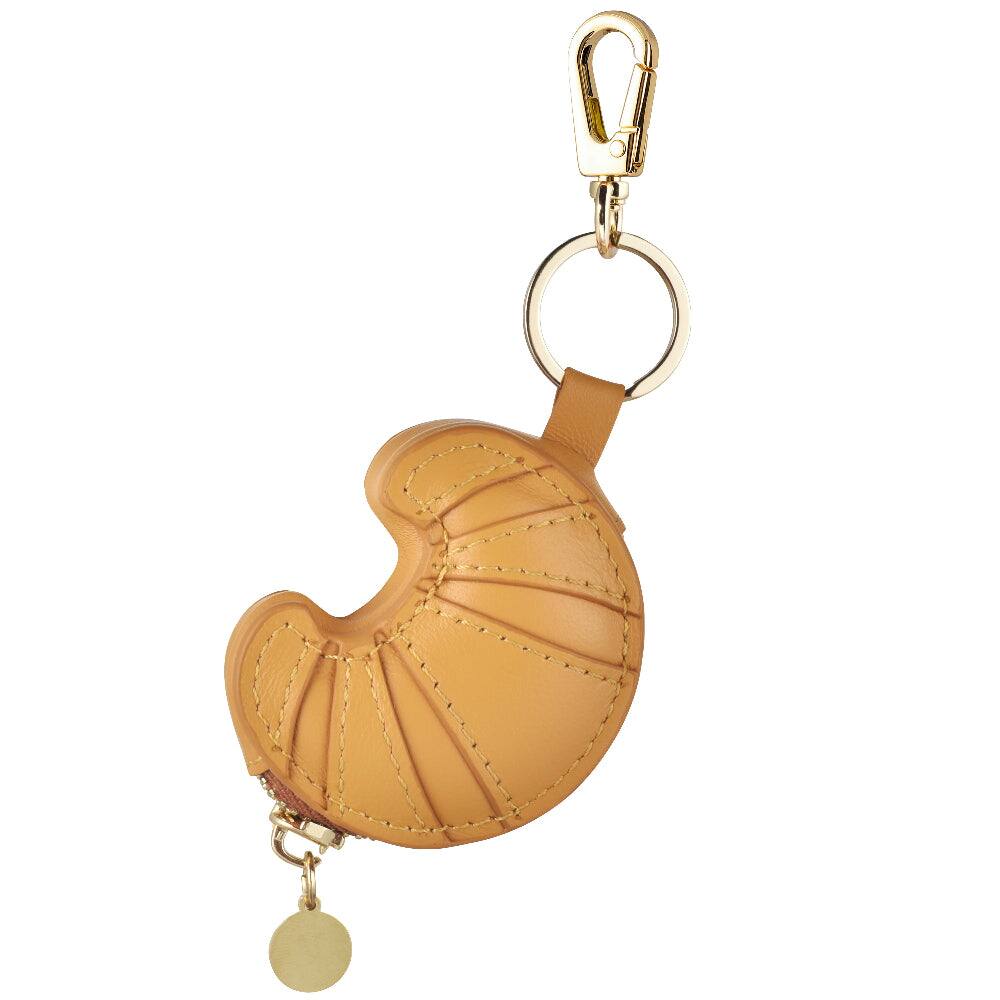 Angle. Posh Tech - Croissant Leather Bag Charm for Airtag® - Brown.