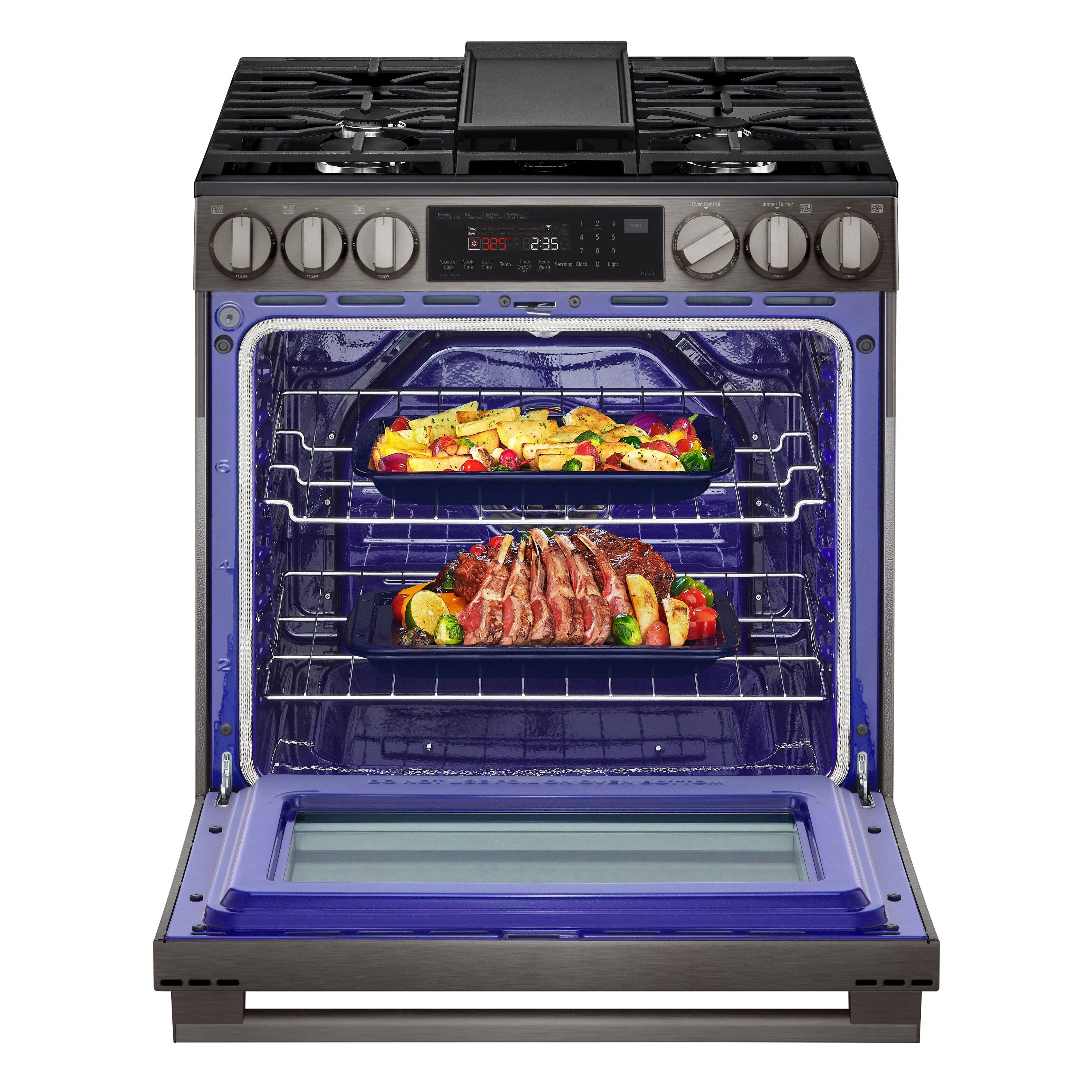 The image shows a blue oven with two trays of food inside. The oven has a digital display with the time of 2:35 displayed. The food appears to be cooking in the oven, and the oven is likely set to cook the food for a specific amount of time. The oven's blue color and the digital display make it a modern and efficient appliance for cooking.