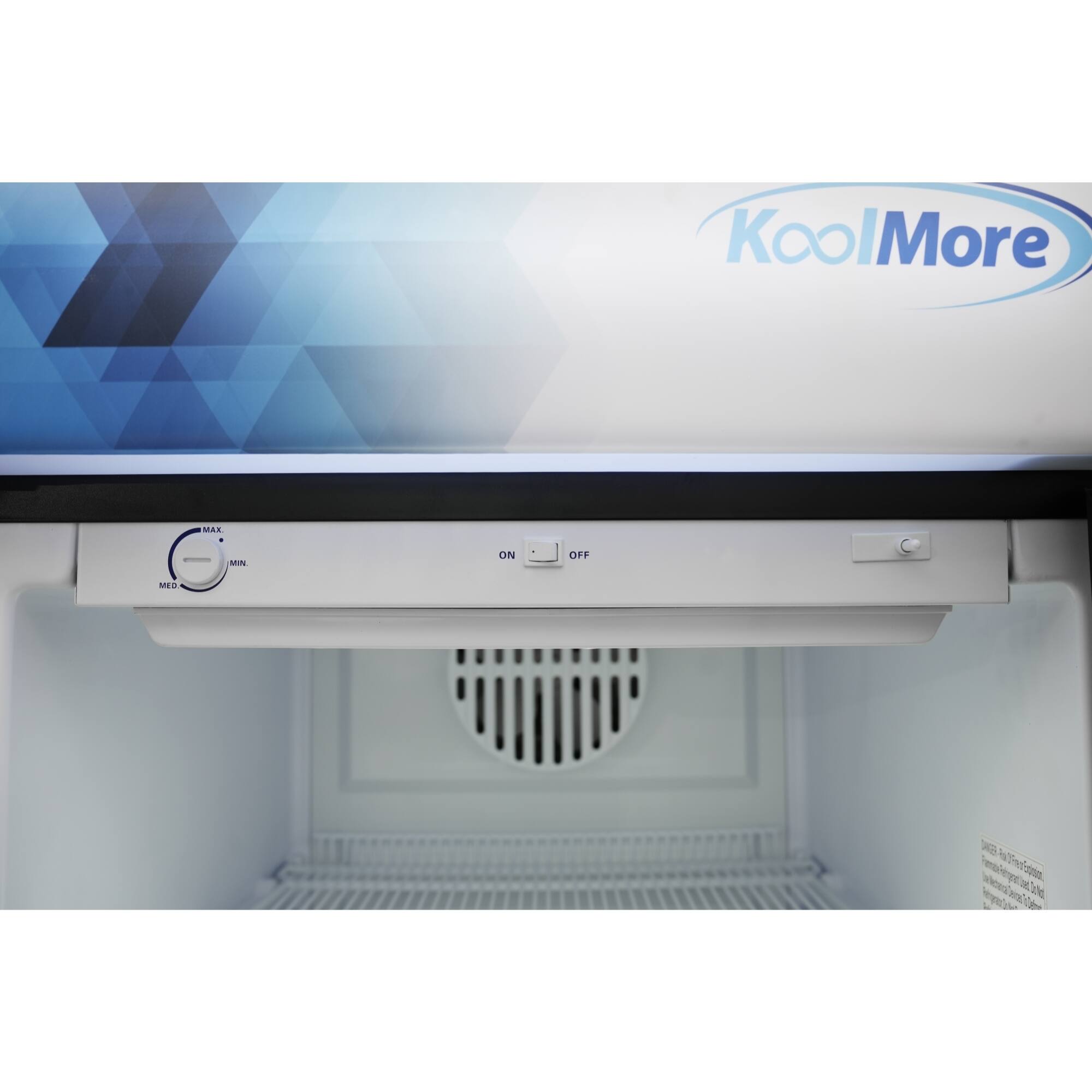 KoolMore is a brand of refrigerator with a white freezer compartment. The freezer has a blue and white design on the door, and it is equipped with a cooling system. The refrigerator has a freezer compartment on top, and it is designed to keep food fresh and cool.