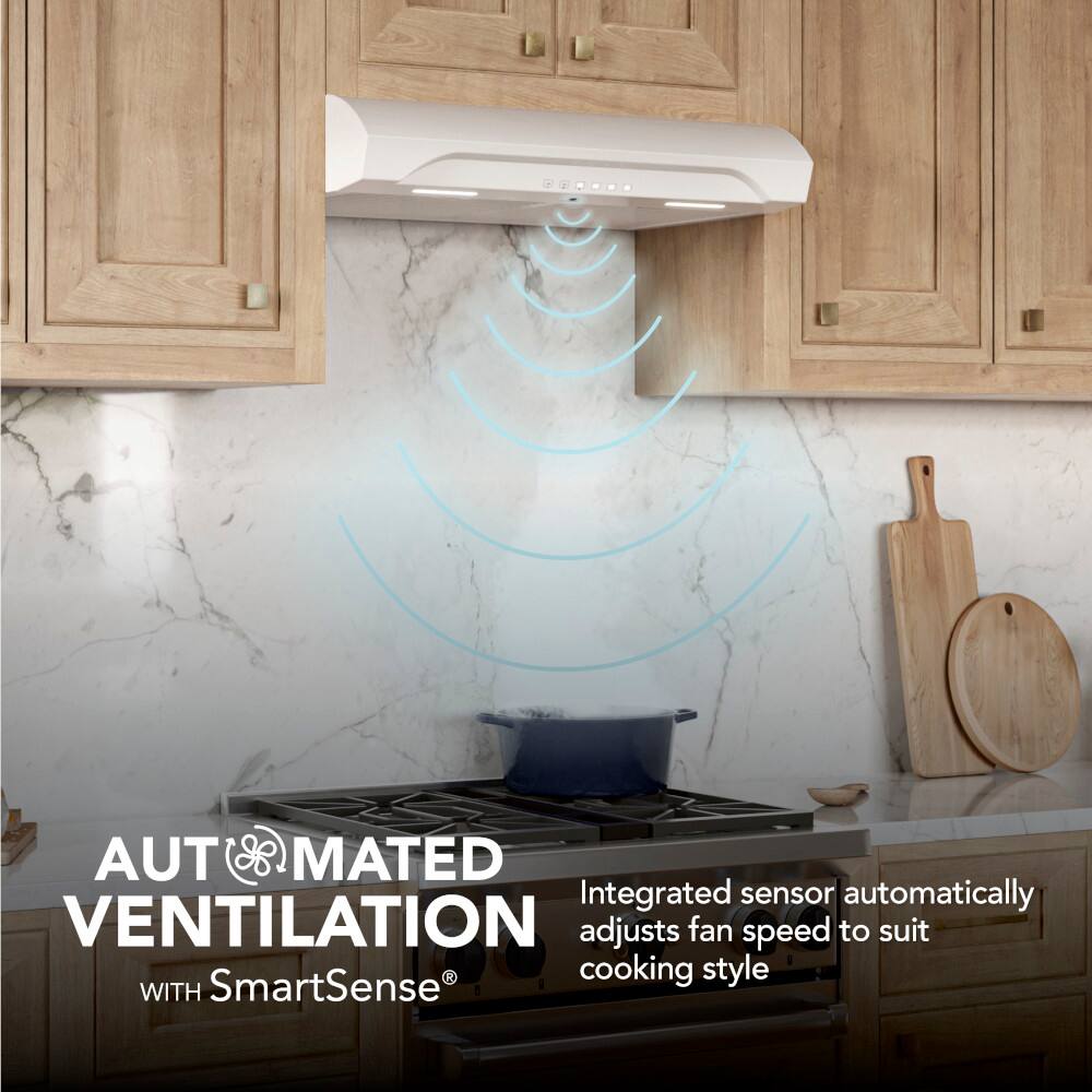 Automated Ventilation with SmartSense: The image showcases an integrated sensor that adjusts the fan speed to suit the cooking style, ensuring a comfortable and efficient cooking experience. The sensor is placed above a stove, and the fan is positioned below it, providing a seamless cooking environment. The image also features a knife and a bowl, indicating that the kitchen is well-equipped for various cooking tasks.