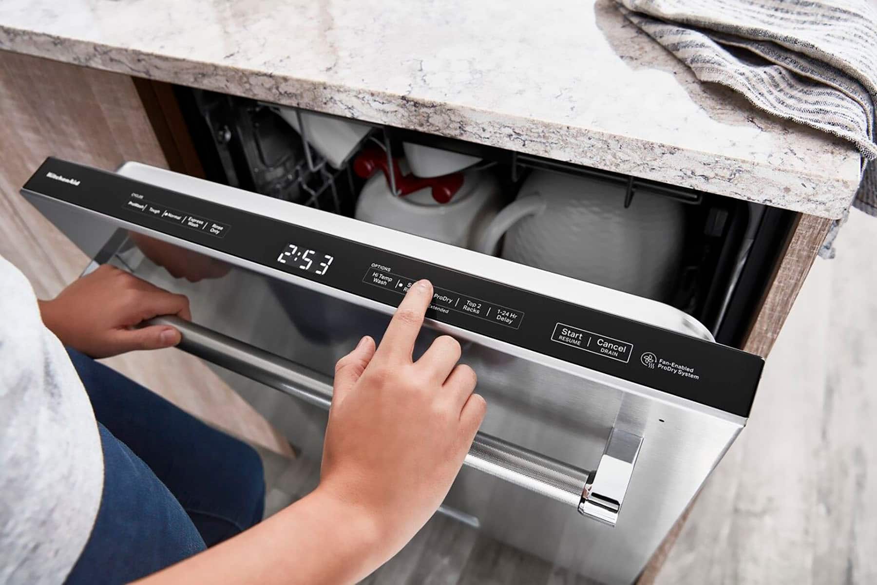 The text on the image reads: "2:53 2:5 3 OPTIONS M Wn Temp ProDry Top 2 otheridted Racks 1-24 Hr Delay RESUME Start Cancel DRAIN 8 ProDry Fan-Enabled System."